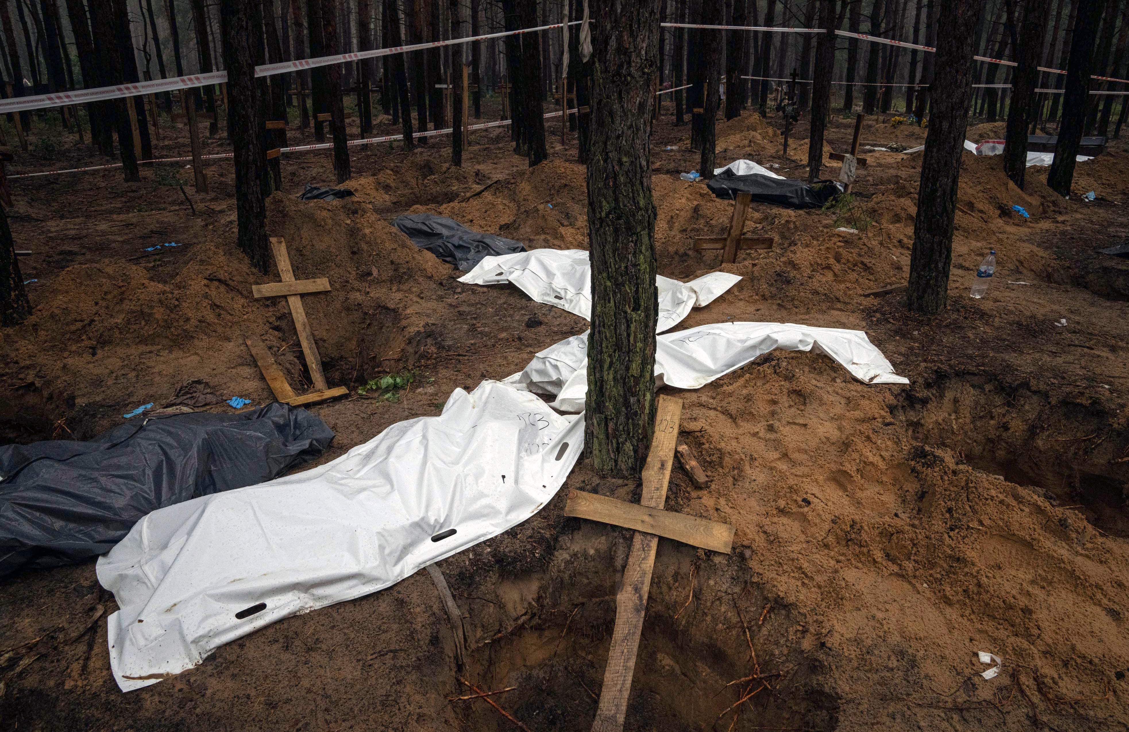 Bags with dead bodies are seen during the exhumation in the recently retaken area of Izium