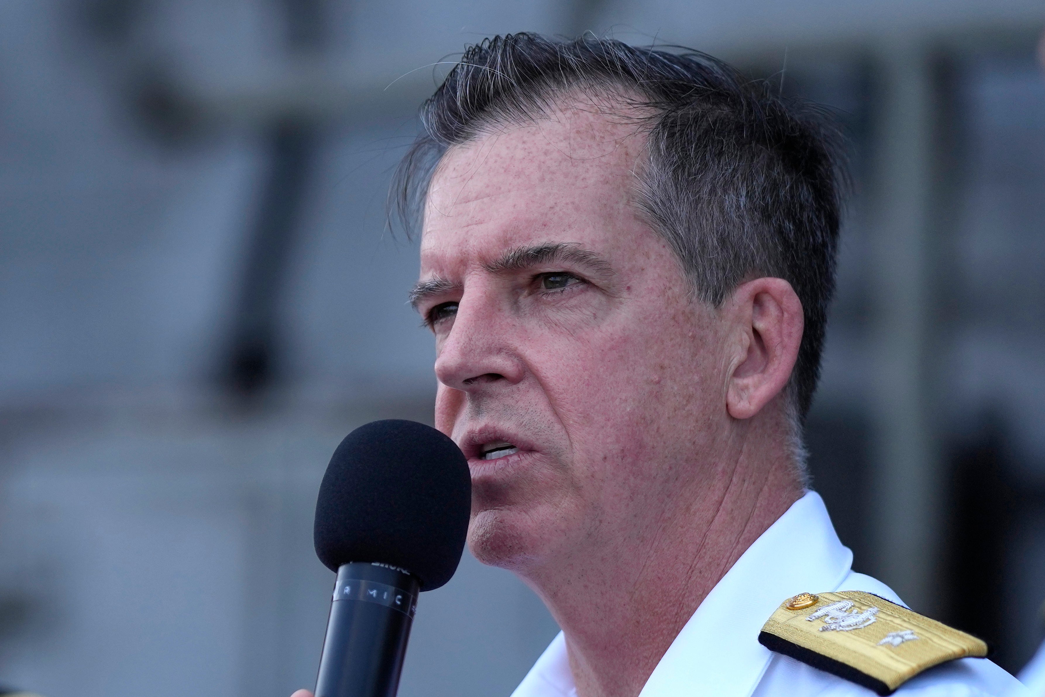 Rear Adm. Michael Donnelly, commander of the carrier strike group answers a reporter’s question during a news conference on the deck of the nuclear-powered aircraft carrier USS Ronald Reagan