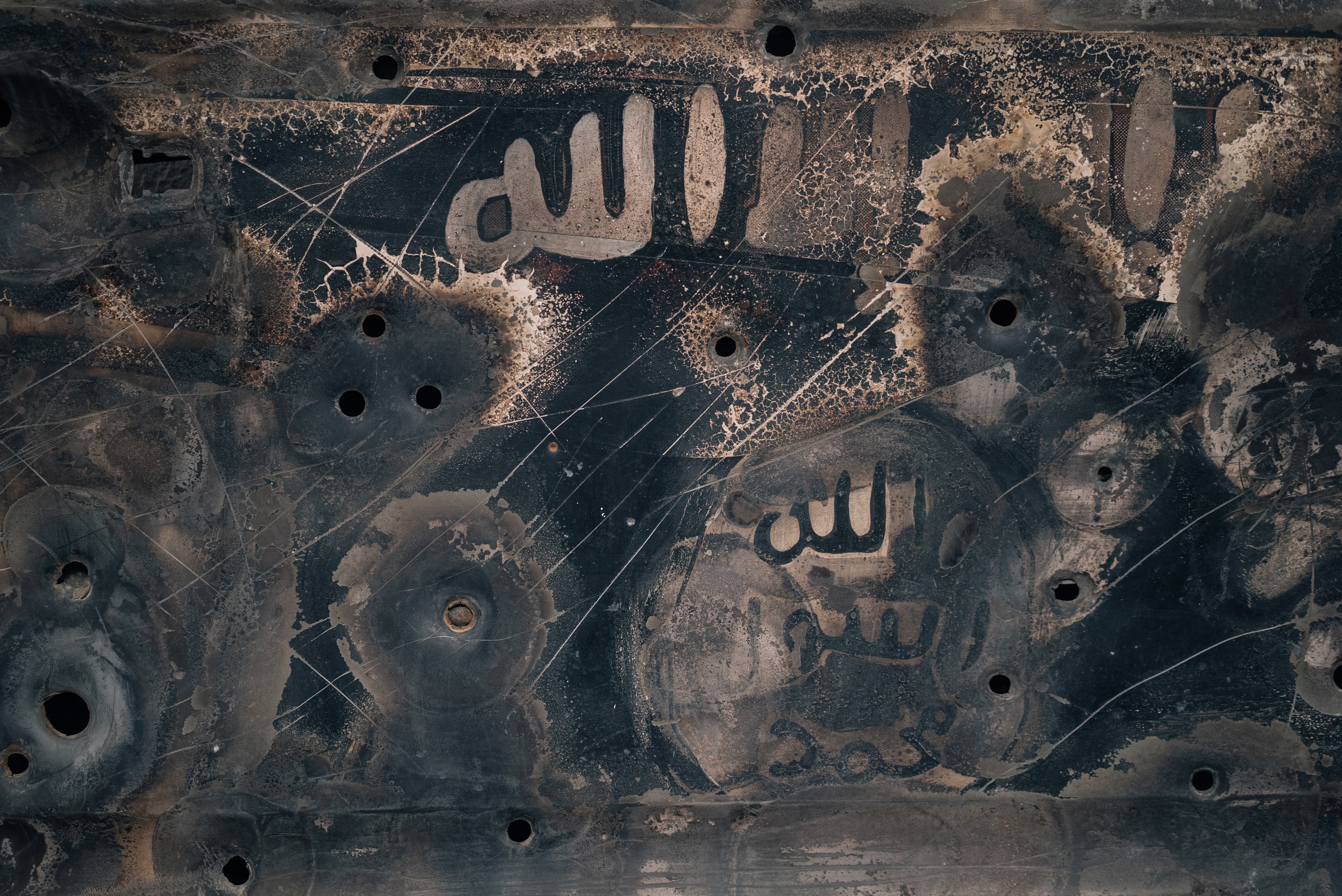 An original car door collected after a car bomb was detonated by Islamic State militants in Iraq is presented by artist Ammar Juma