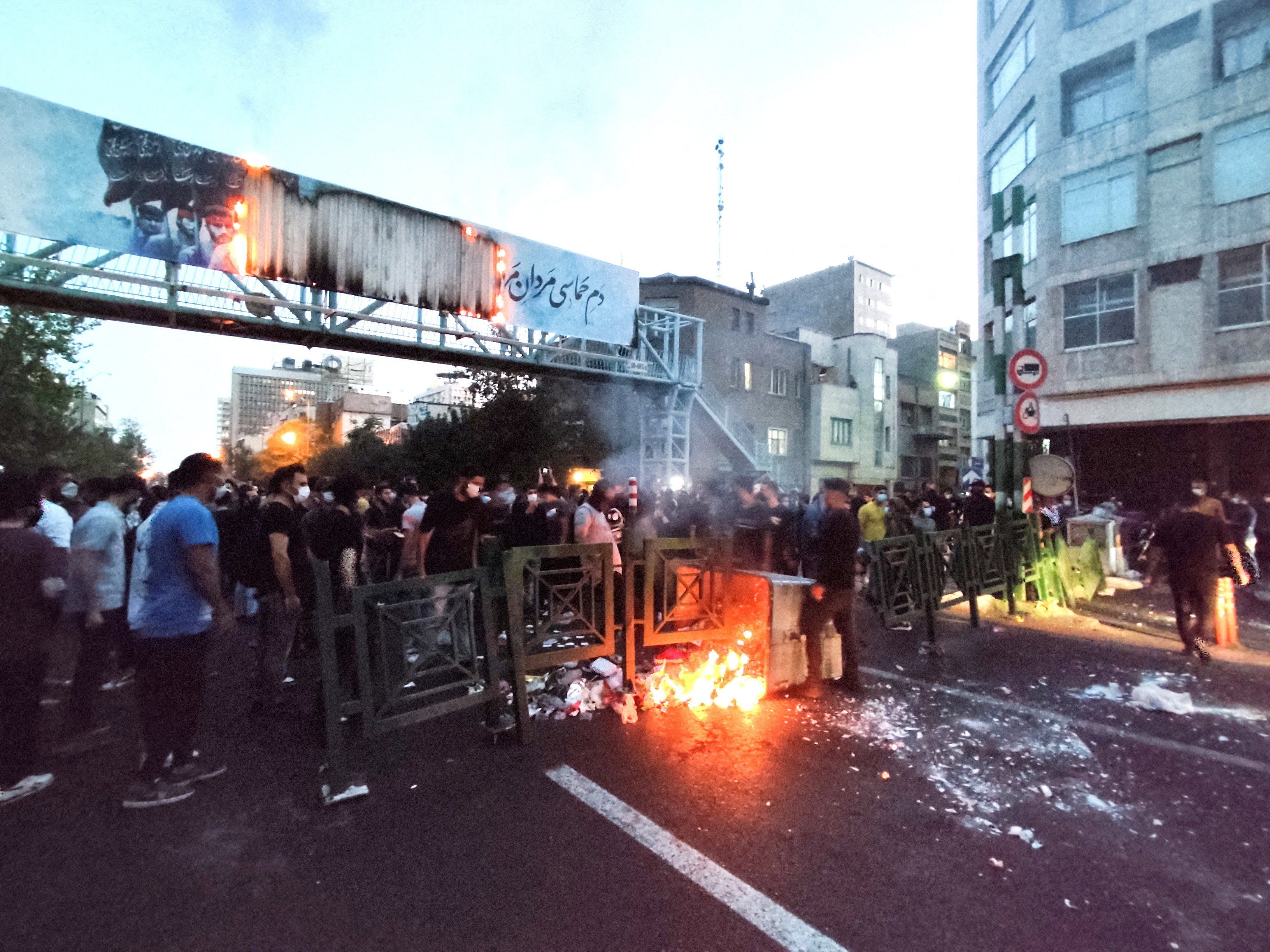 People light a fire during a protest in Tehran earlier this week