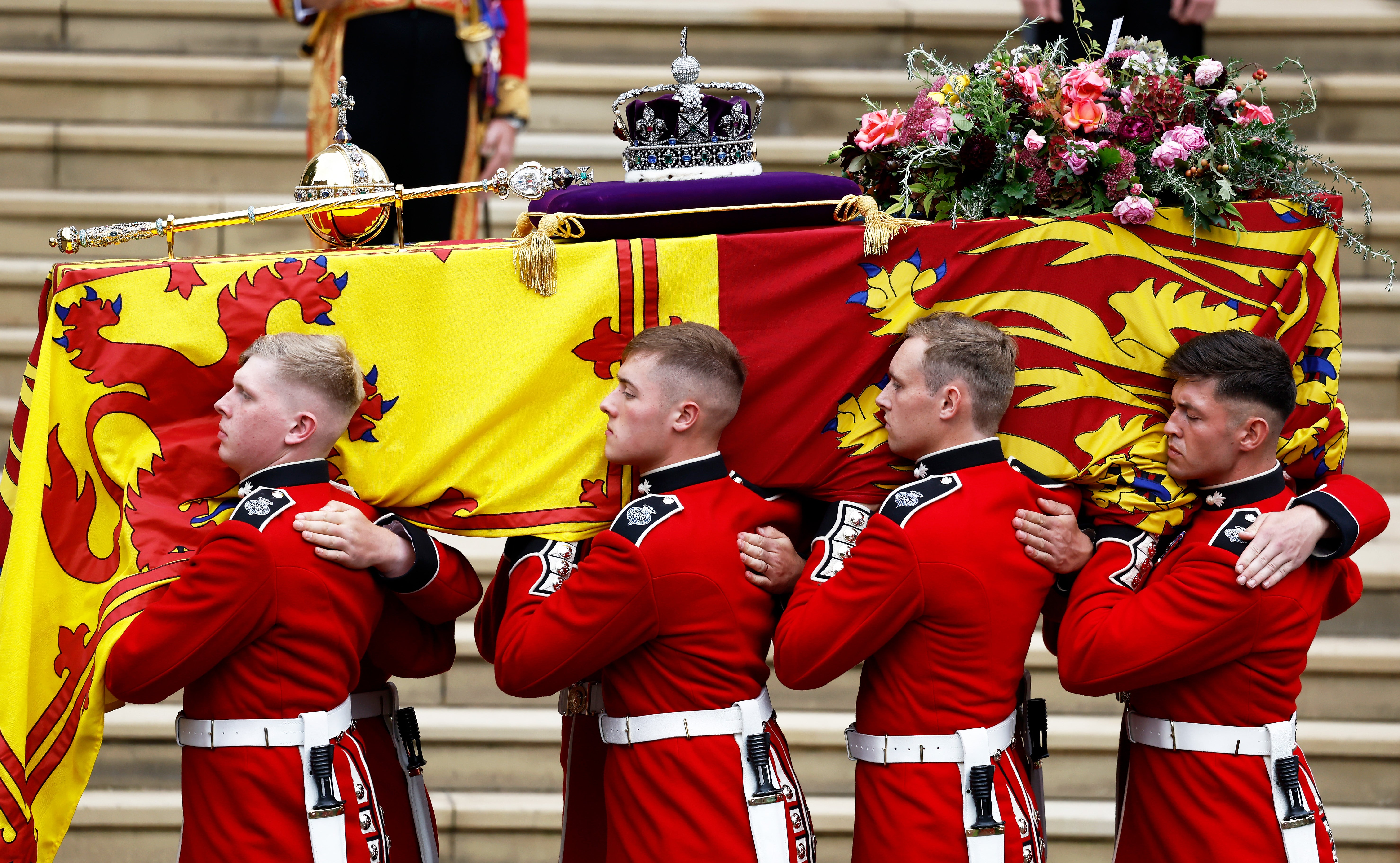 David Sanderson is seen carrying the Queen’s coffin at the front. Pall bearers carry the coffin of Queen Elizabeth II with the Imperial State Crown resting on top to St. George's Chapel