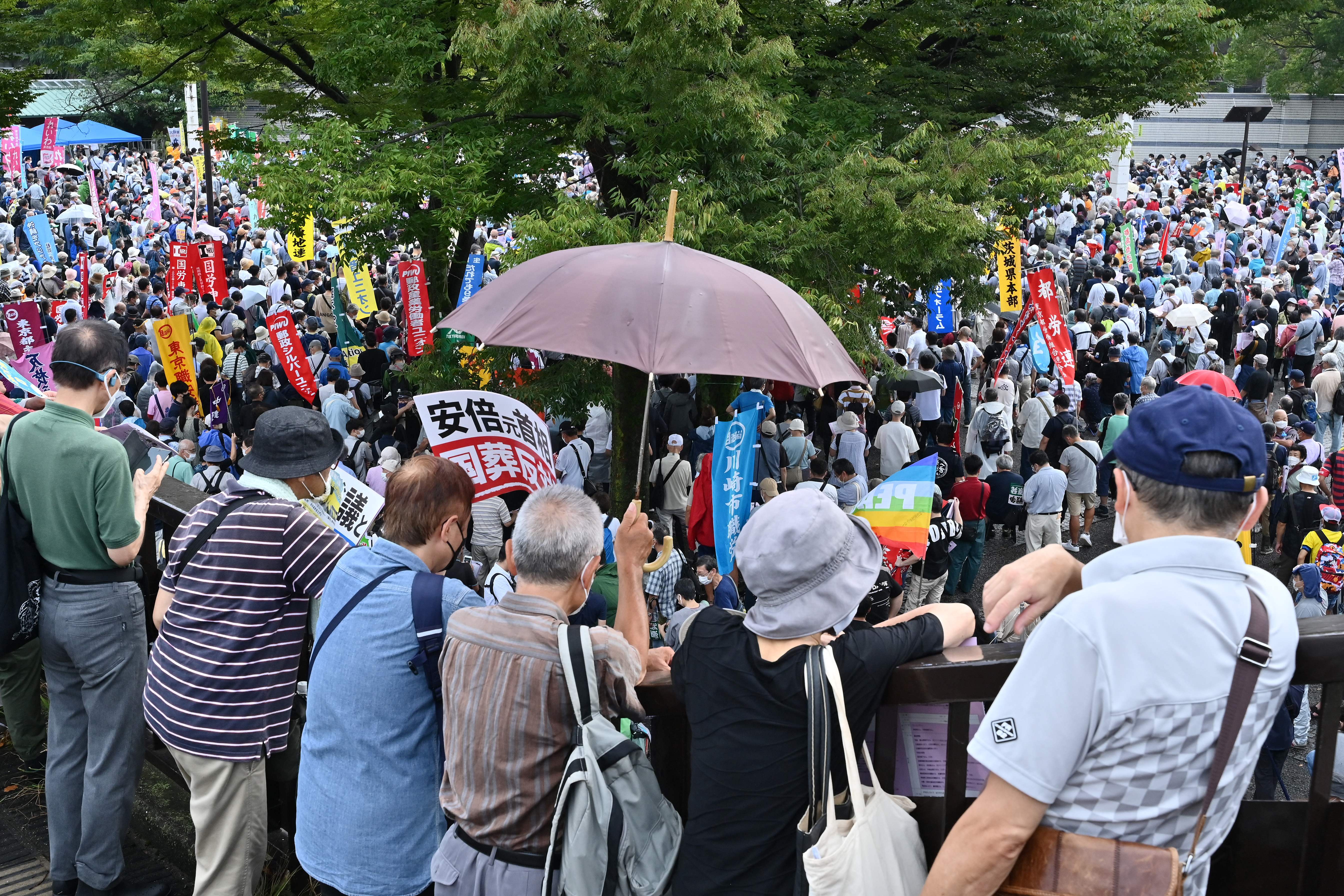 People gather to listen to speeches as anti-war, anti-nuclear and protesters against the government’s funding for the funeral of late Japanese prime minister Shinzo Abe