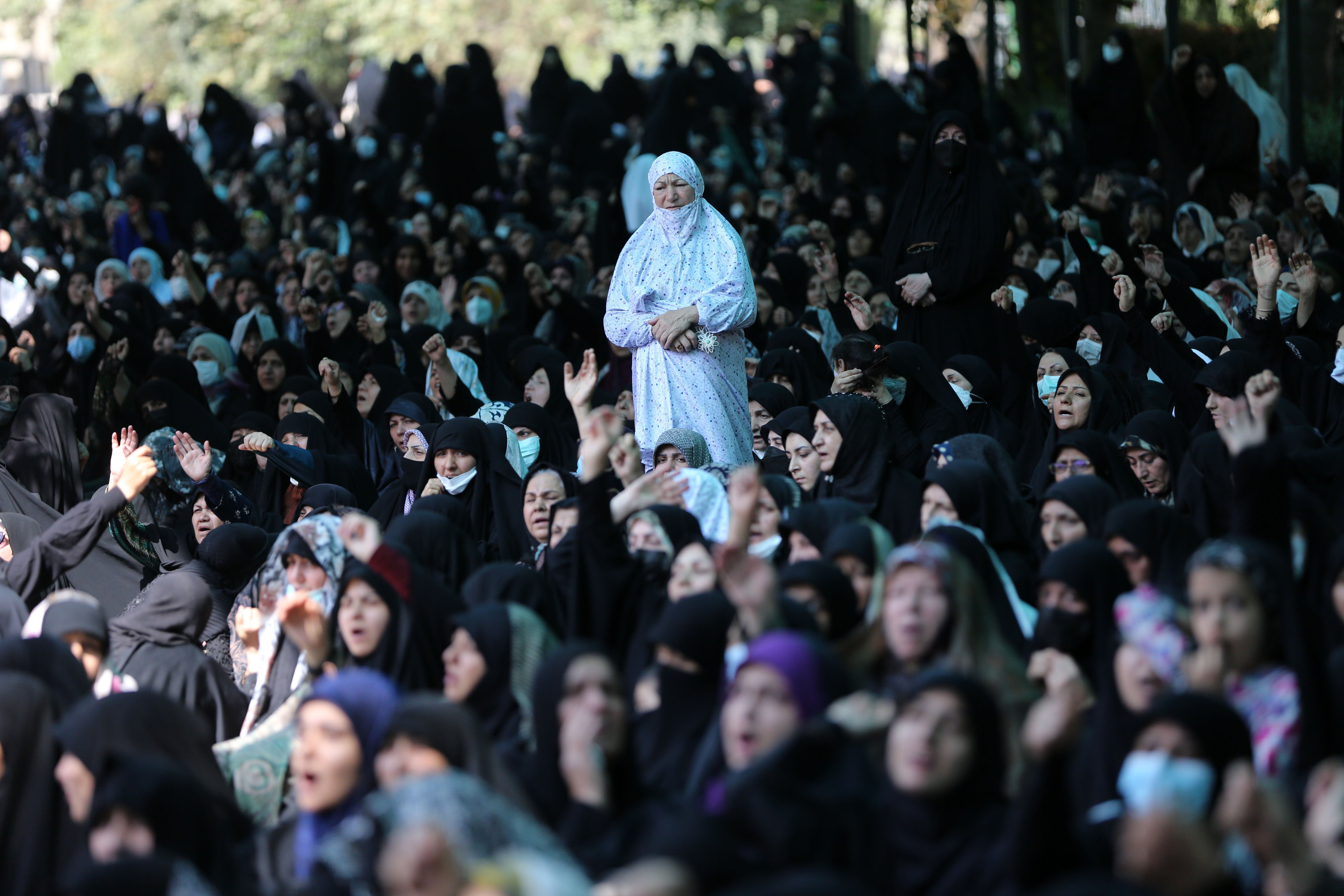 Iranians shout pro-government slogans after performing Friday prayer at Tehran University