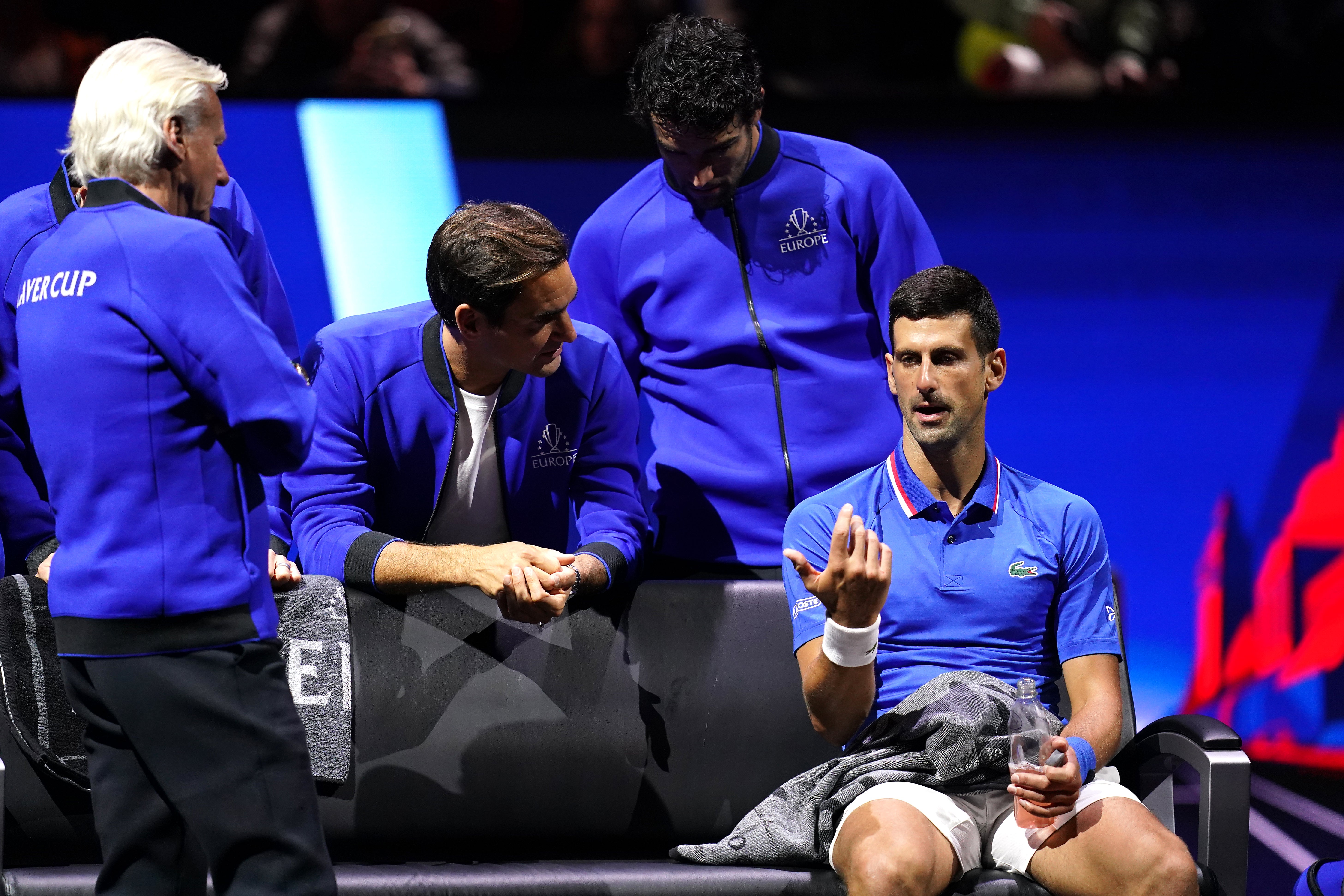 Novak Djokovic speaks with captain Bjorn Borg and Roger Federer (John Walton/PA)