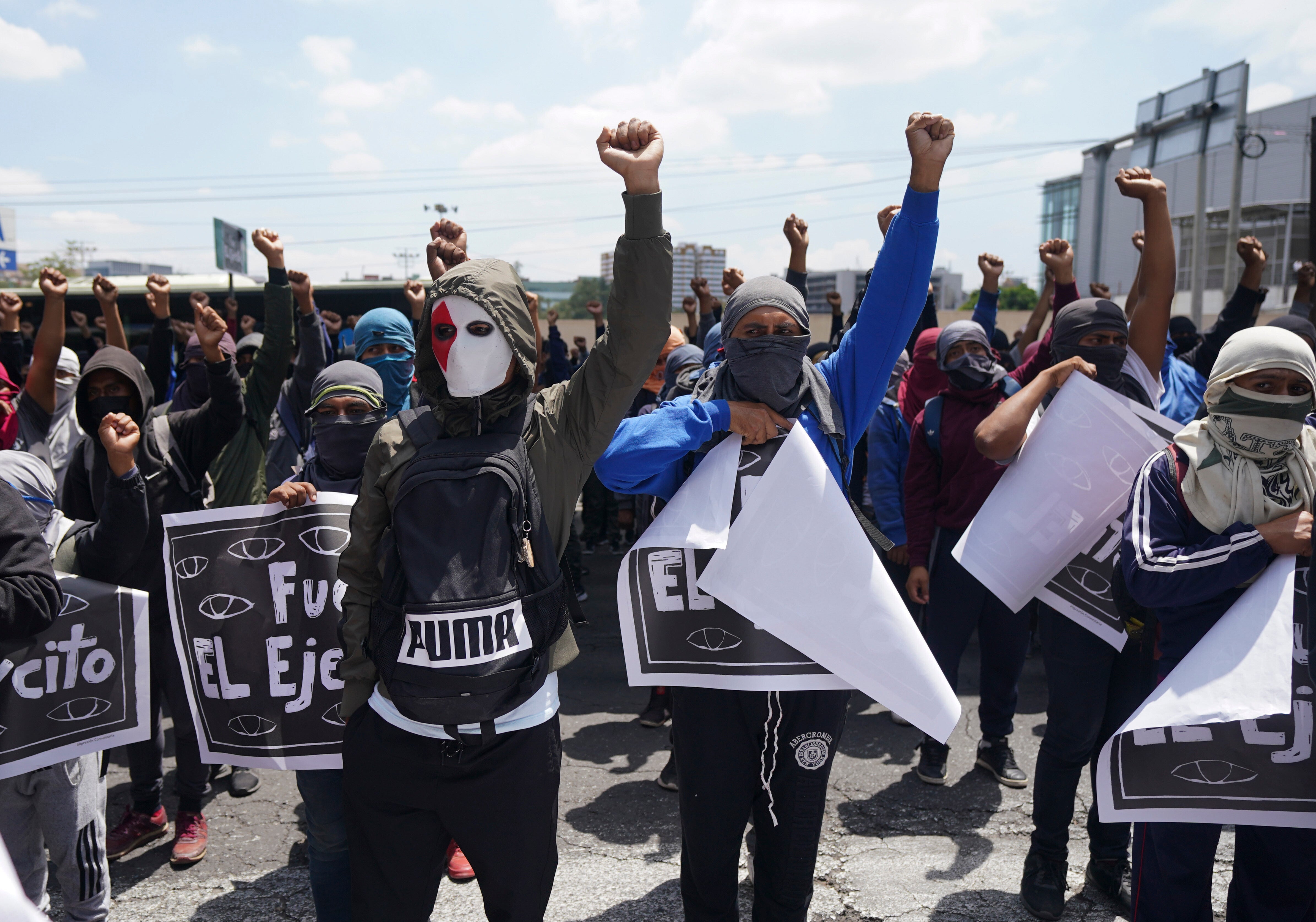 Demonstrators protesting the 2014 disappearance of 43 college students hold signs with a message that reads in Spanish: ‘It was the Army’ in reference to the missing students,