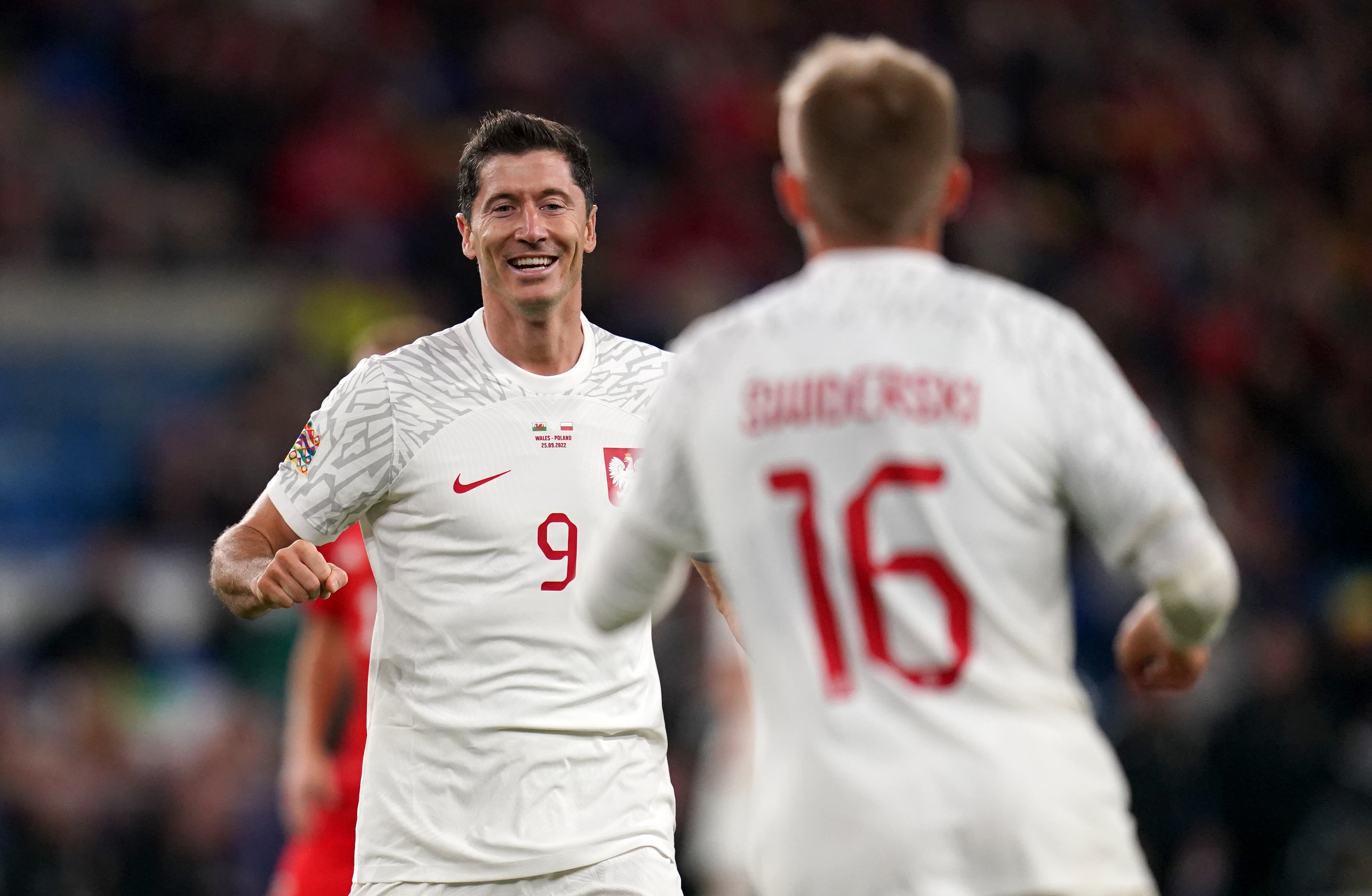 Poland’s Robert Lewandowski (left) celebrates with goalscorer Karol Swiderski after setting up Poland’s winner against Wales in Cardiff (Nick Potts/PA)