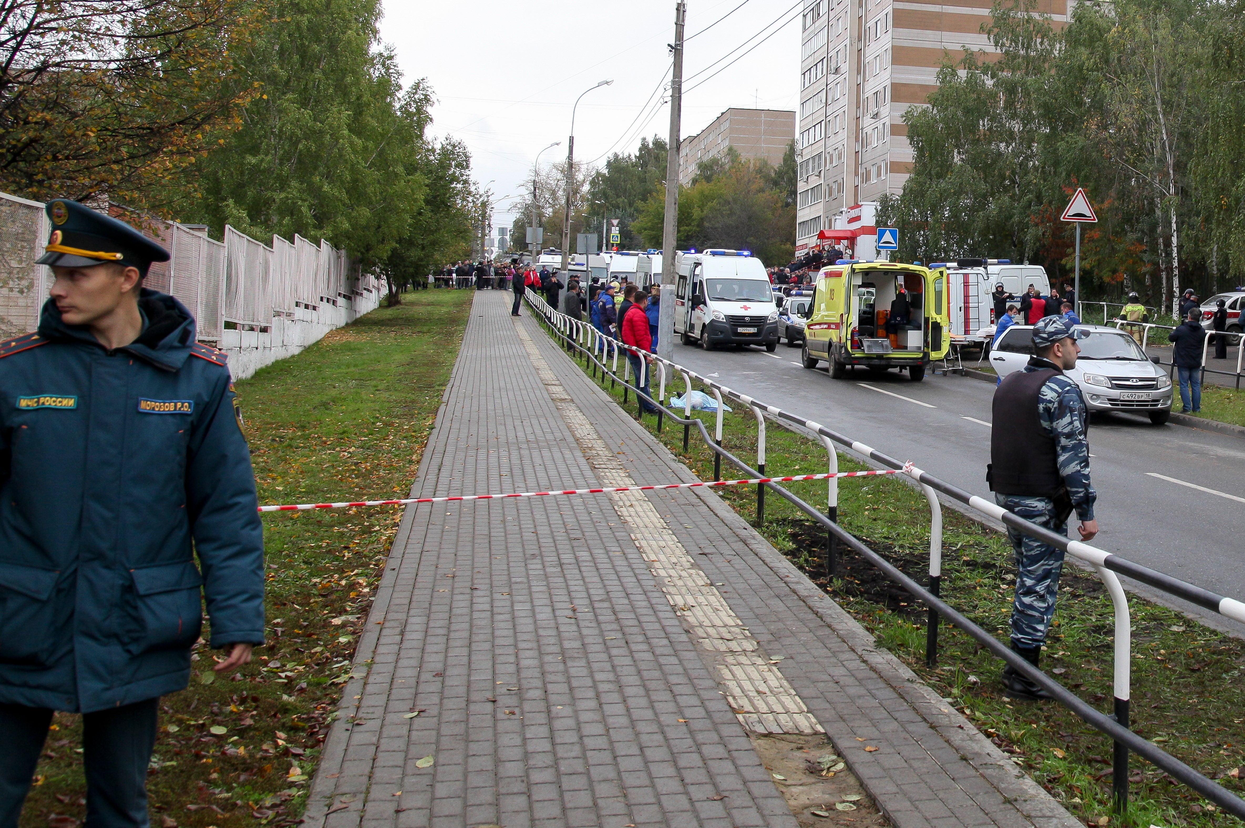 Police block an area as investigators and paramedics work at the scene of the shooting