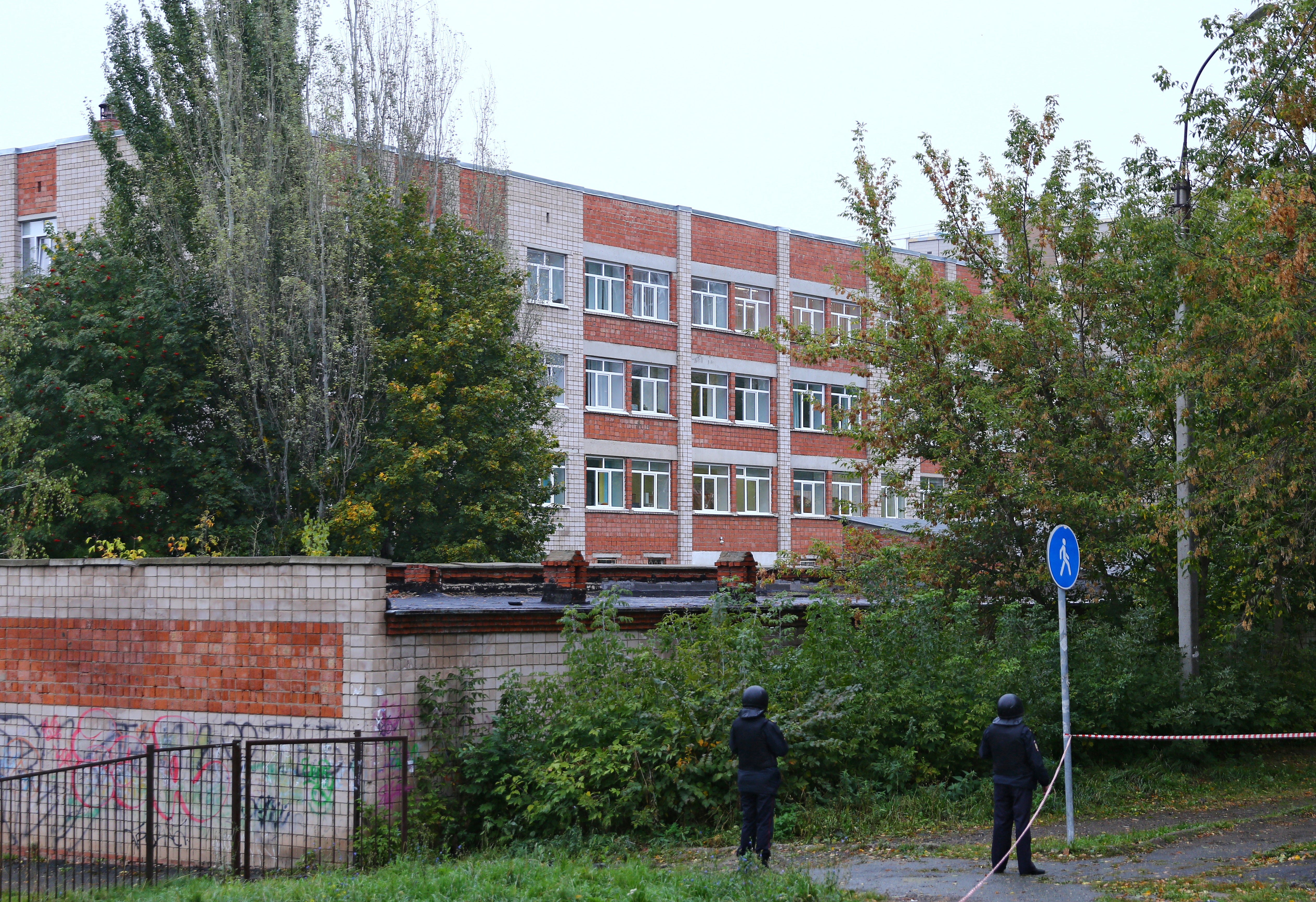 Police officers secure the area near the school