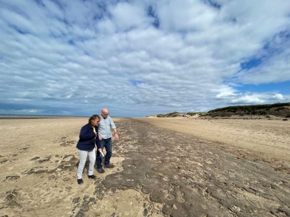 Dr Alison Burns and Professor Jamie Woodward inspecting 8,500-year-old animal and human footprints