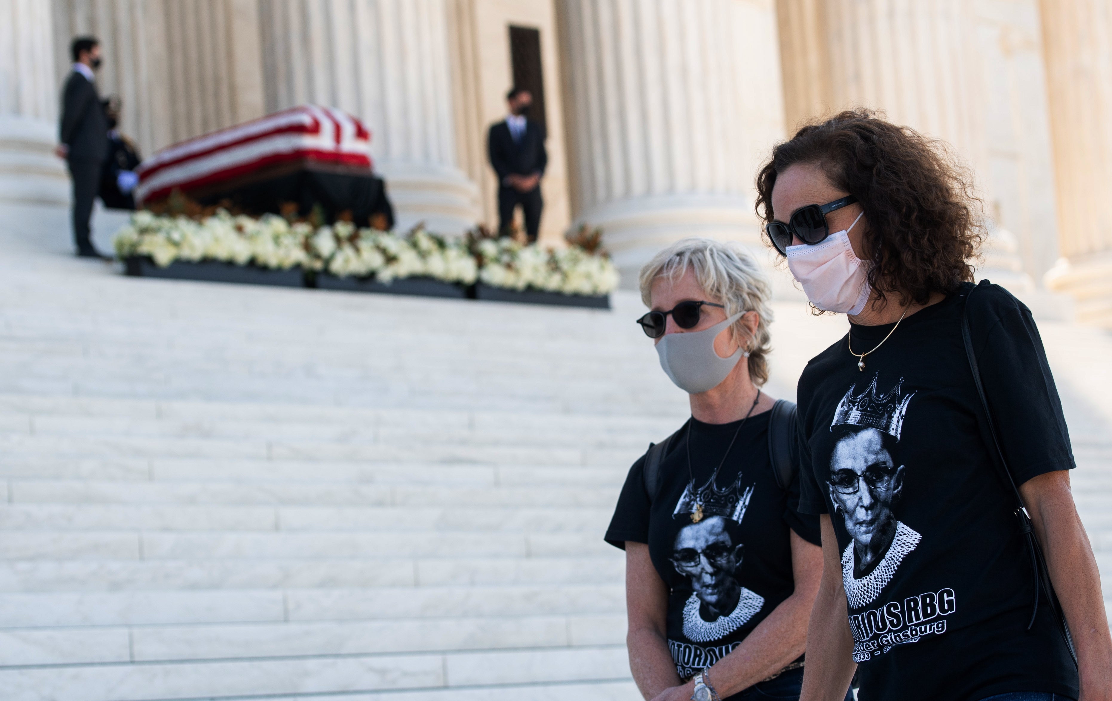 People with ‘Notorious RBG’ T-shirts walk past the casket of the late Supreme Court justice on the steps of the US Supreme Court in September 2020