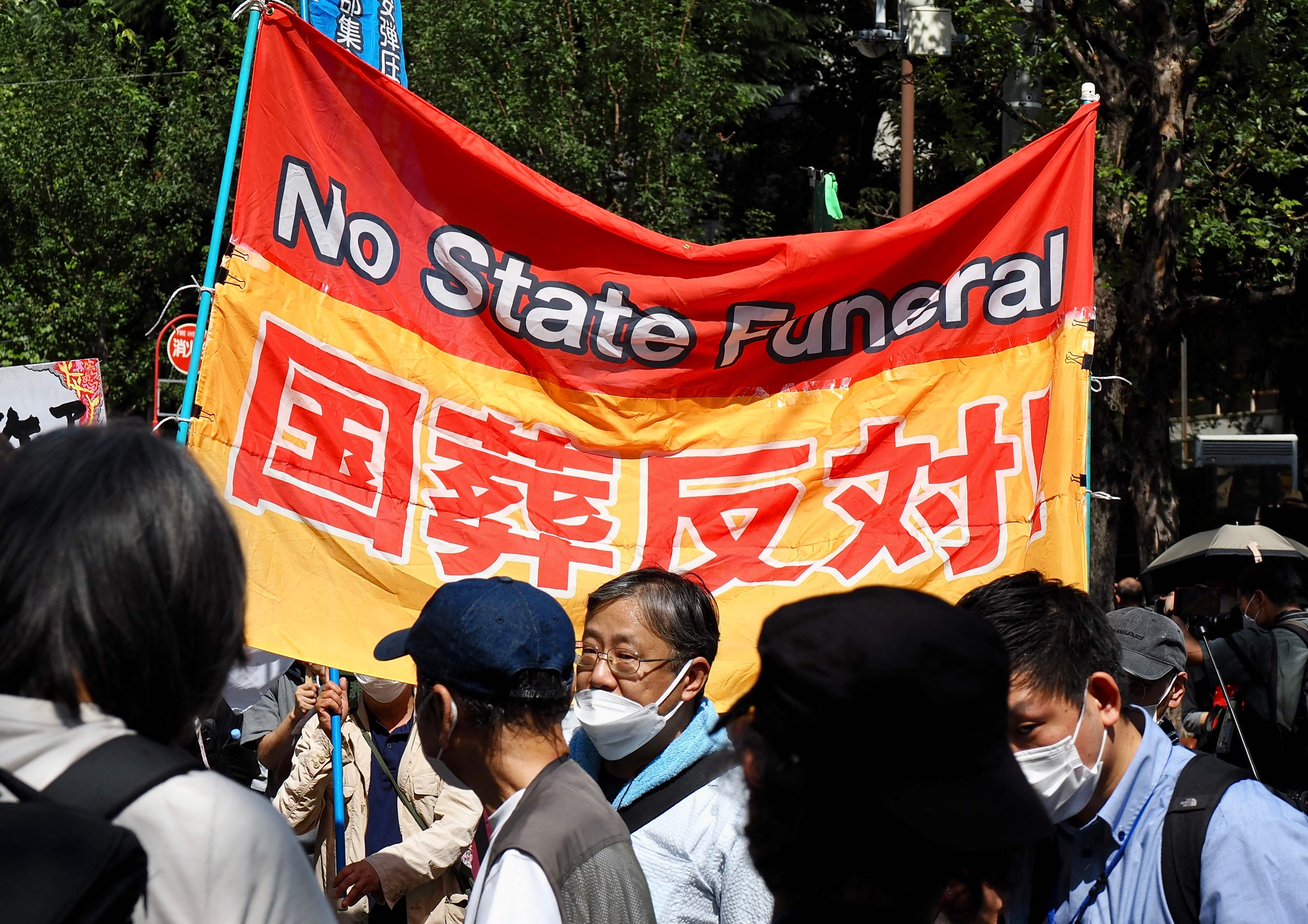 Protesters in Tokyo hold a banner opposing the state funeral