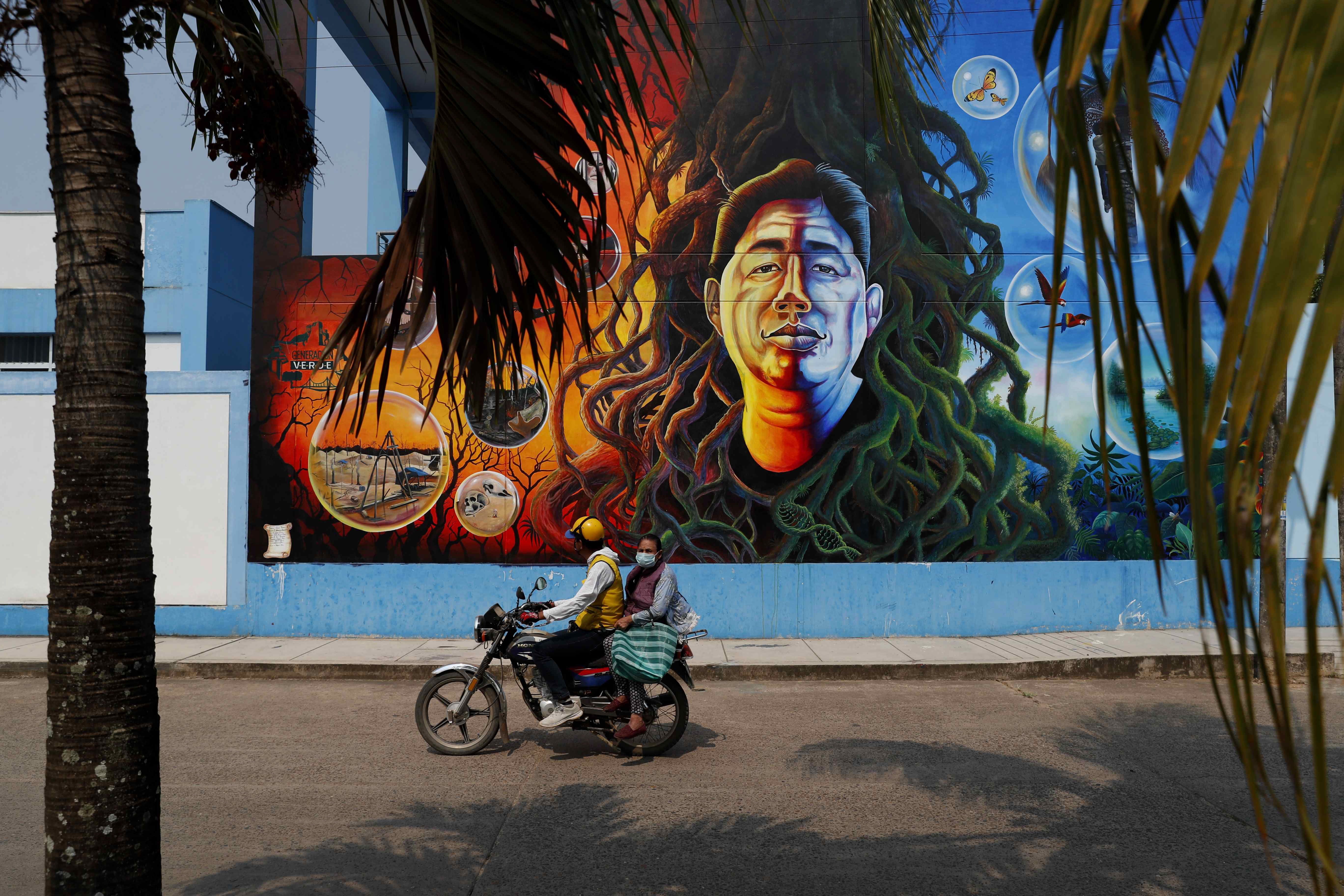 A mural of environmental defender Roberto Pacheco assassinated in 2020 while guarding his land, in Puerto Maldonado, Peru