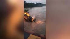 Digger in India falls into canal after dismantling bridge