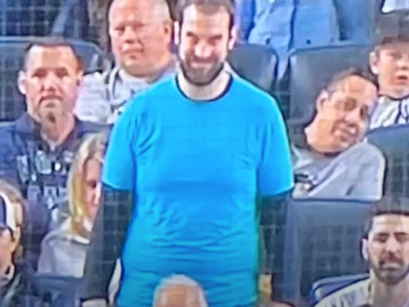 An actor promoting the Paramount Pictures horror film “Smile” in the background of a baseball game