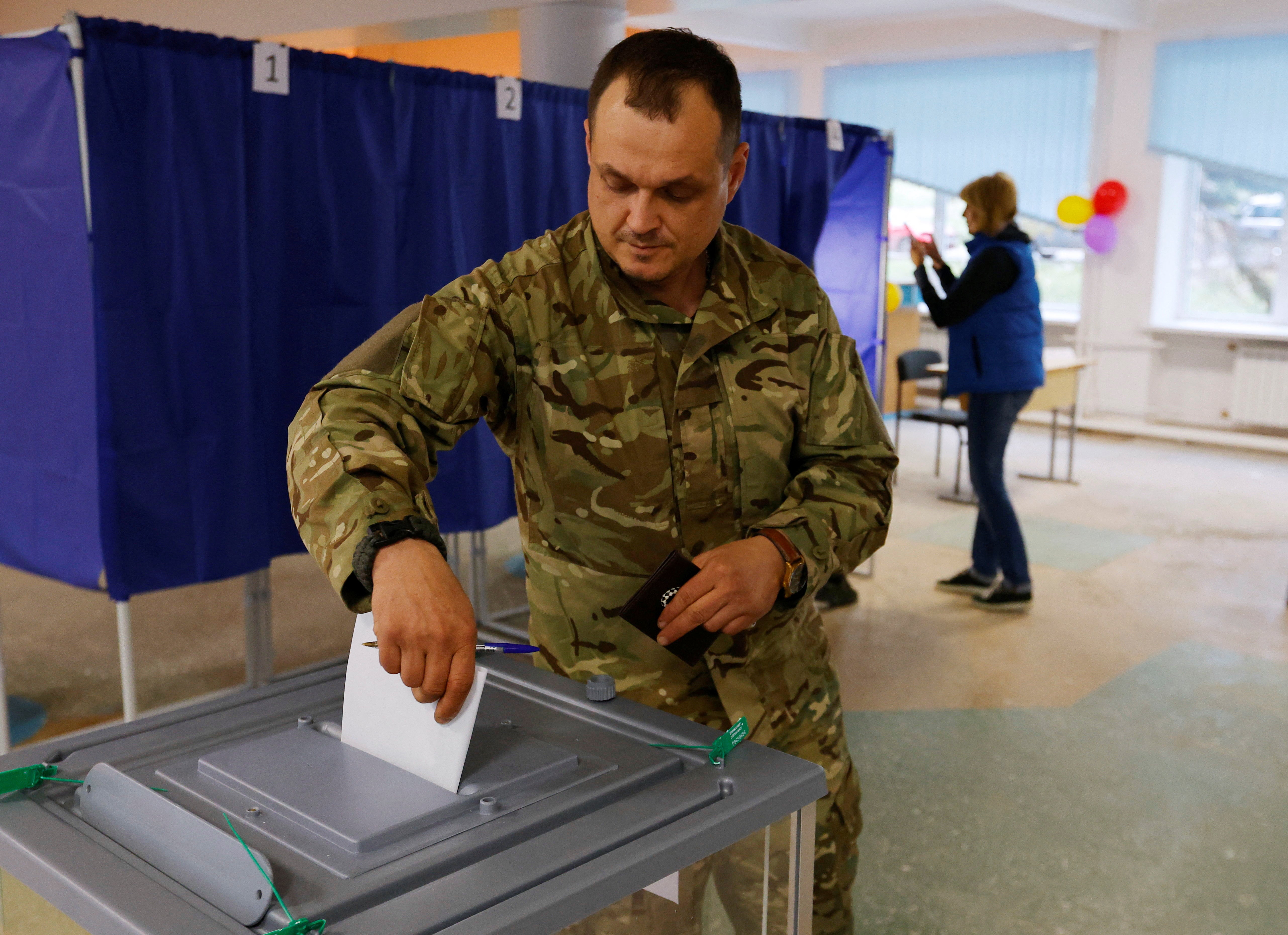 A man votes at a polling station during a “sham” referendum in Donetsk province, Ukraine