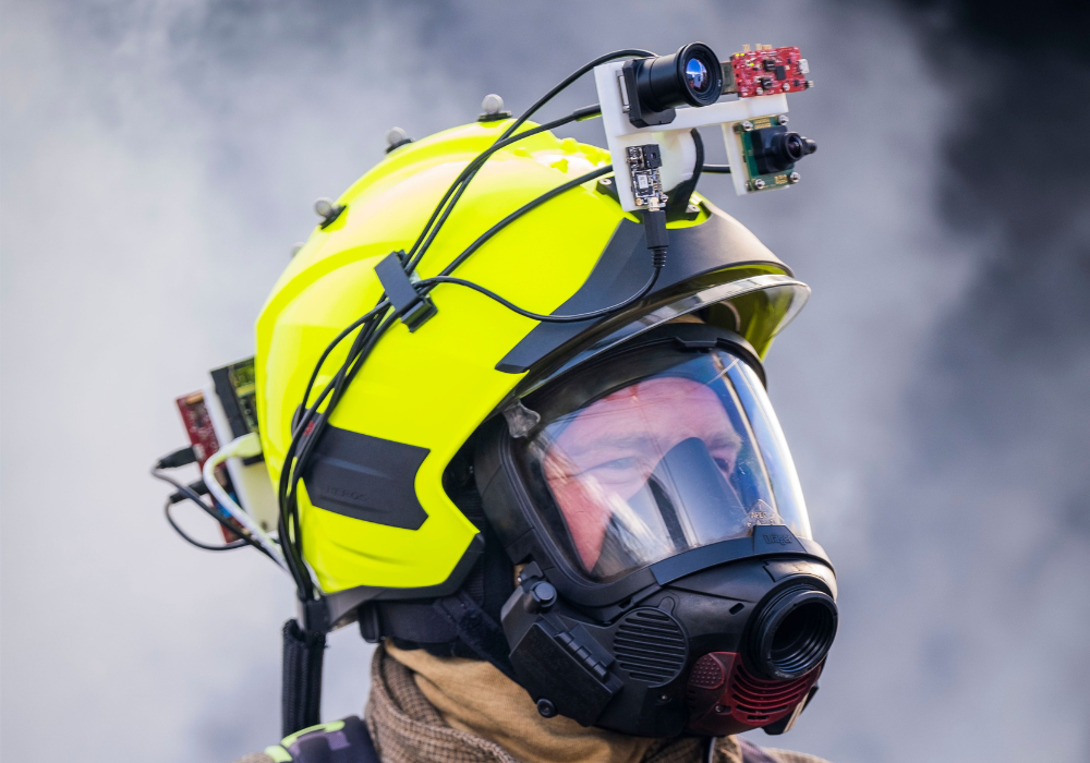 A firefighter wears a helmet enhanced with sensors and cameras allowing them to locate victims more quickly (Craig Watt/PA)