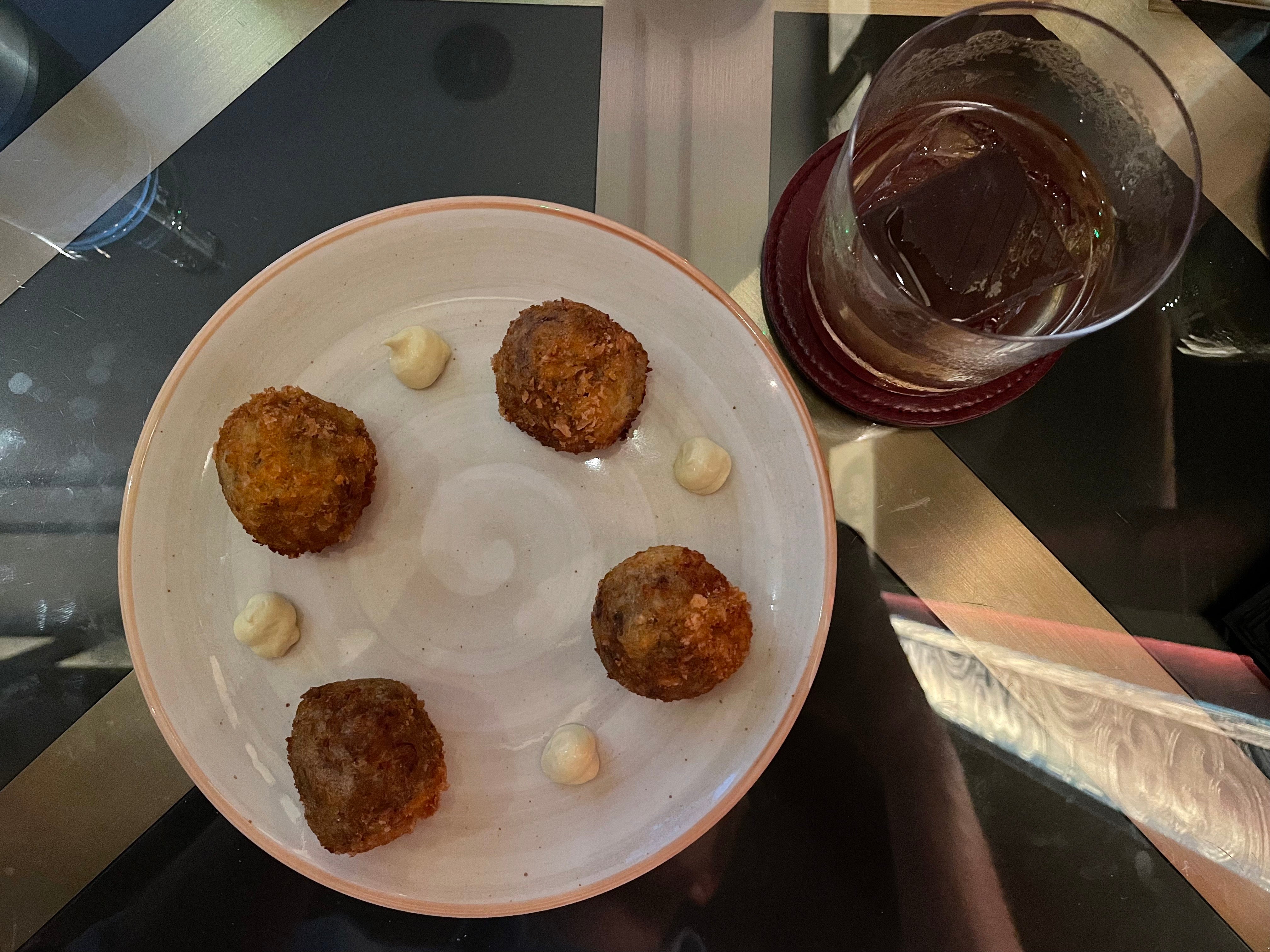 The bar snacks menu, featuring truffle arancini, sets the bar high