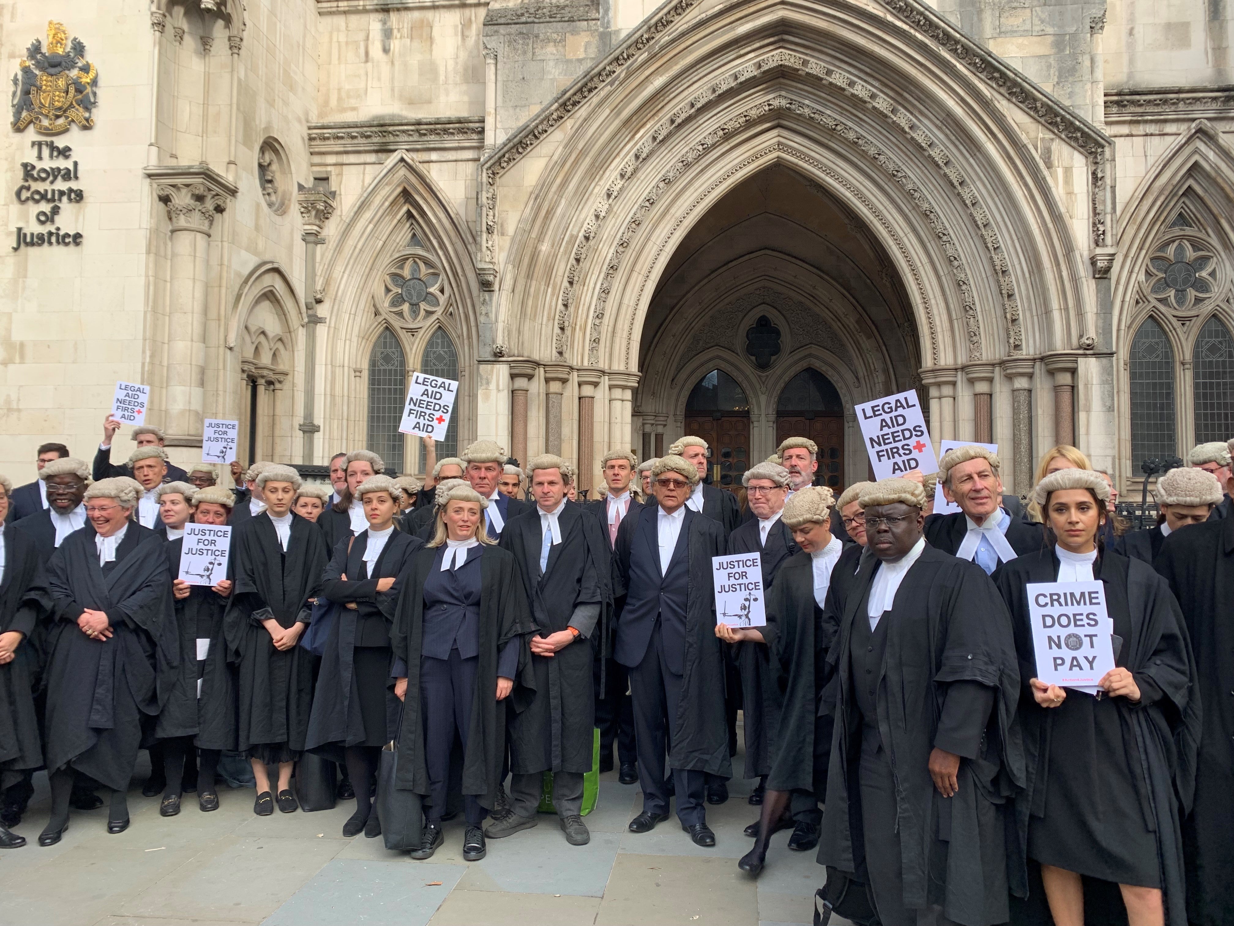 Criminal barristers from the Criminal Bar Association demonstrate outside the Royal Courts of Justice in London, as part of their ongoing pay row with the Government (Tom Pilgrim/PA)