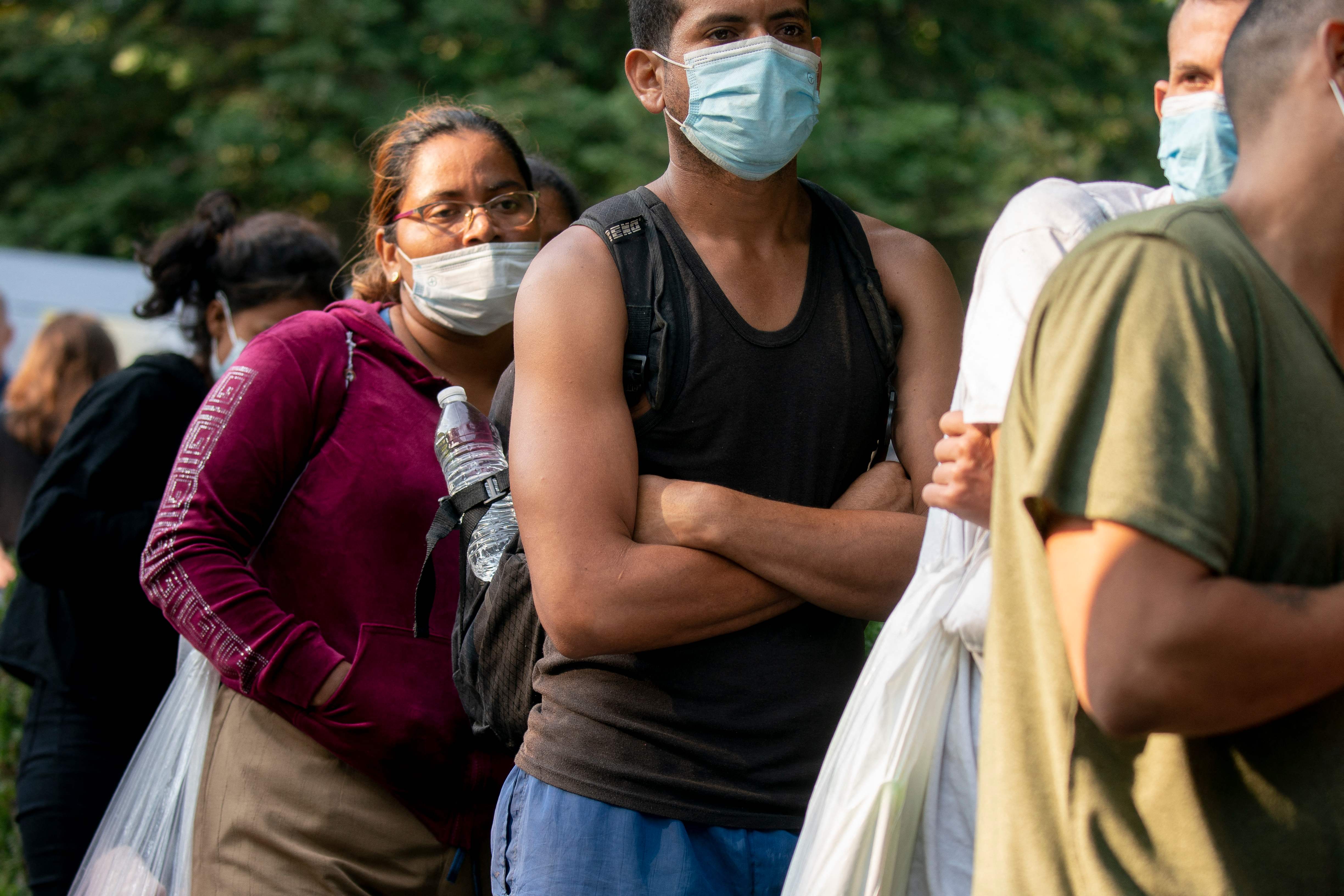 A group of mostly Venezuelan migrants dropped off outside Vice President Kamala Harris’s residence in Washington DC wait for transport to a local church on 15 September.