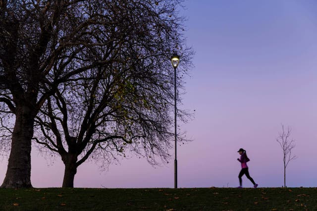 <p>A woman running at dusk</p>