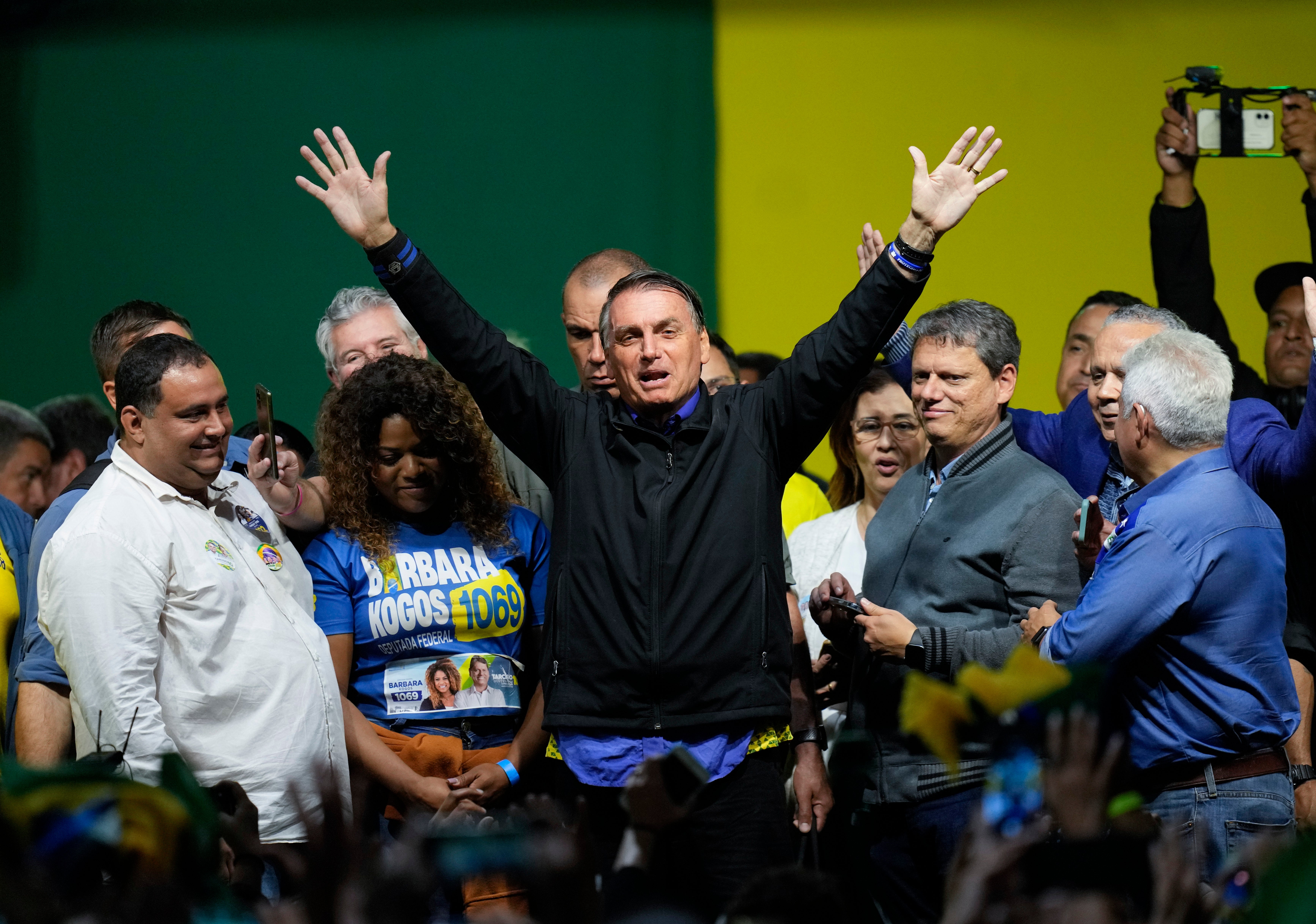 Brazilian president Jair Bolsonaro, who is running for a second term, waves to supporters during a campaign rally in Santos last month