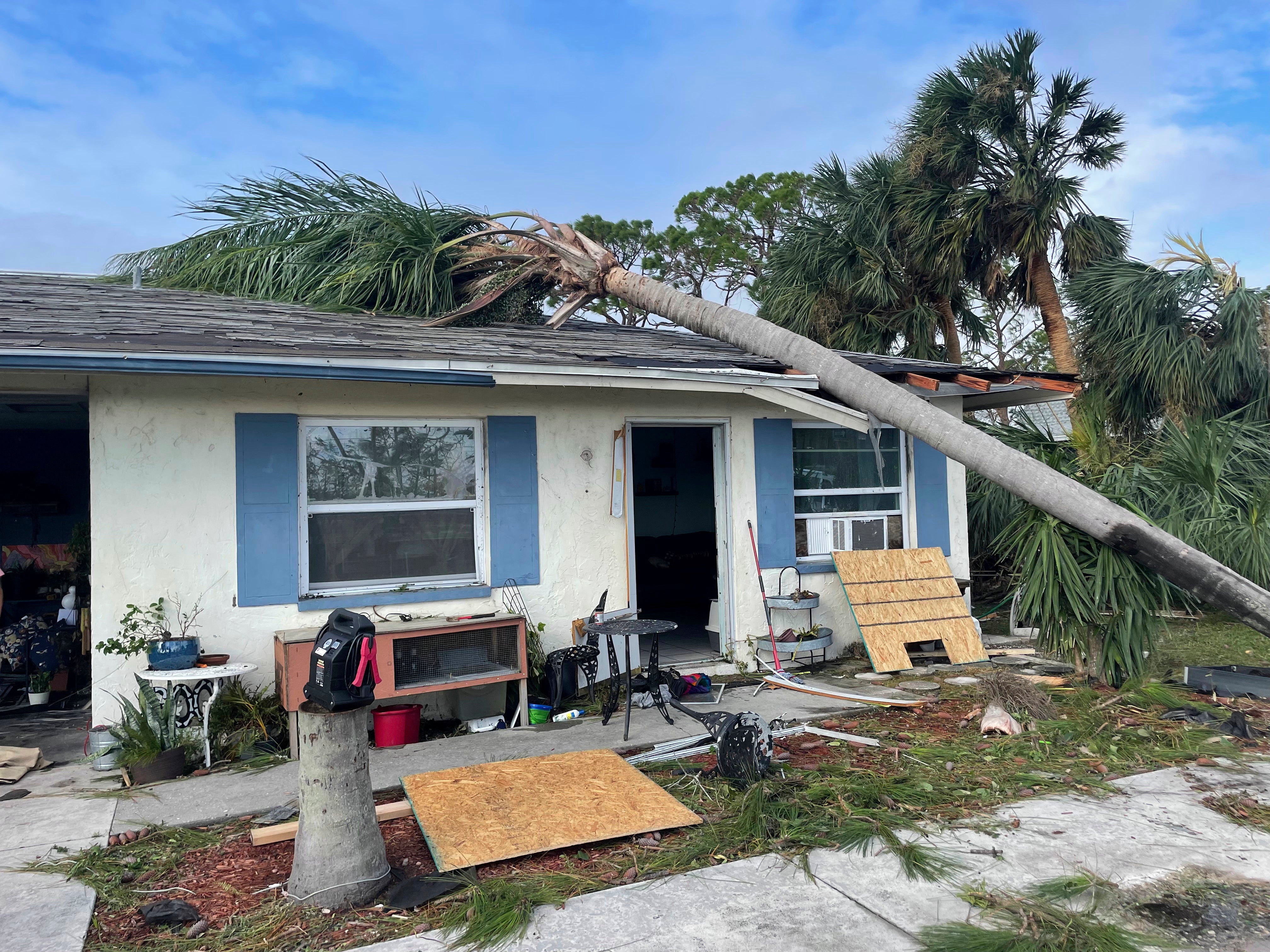 In this photo provided by Cheynne Prevatt, Prevatt's home, seen Thursday, Sept. 29, 2022, was damaged by Hurricane Ian and by a fallen palm tree, making it uninhabitable, in Englewood, Florida