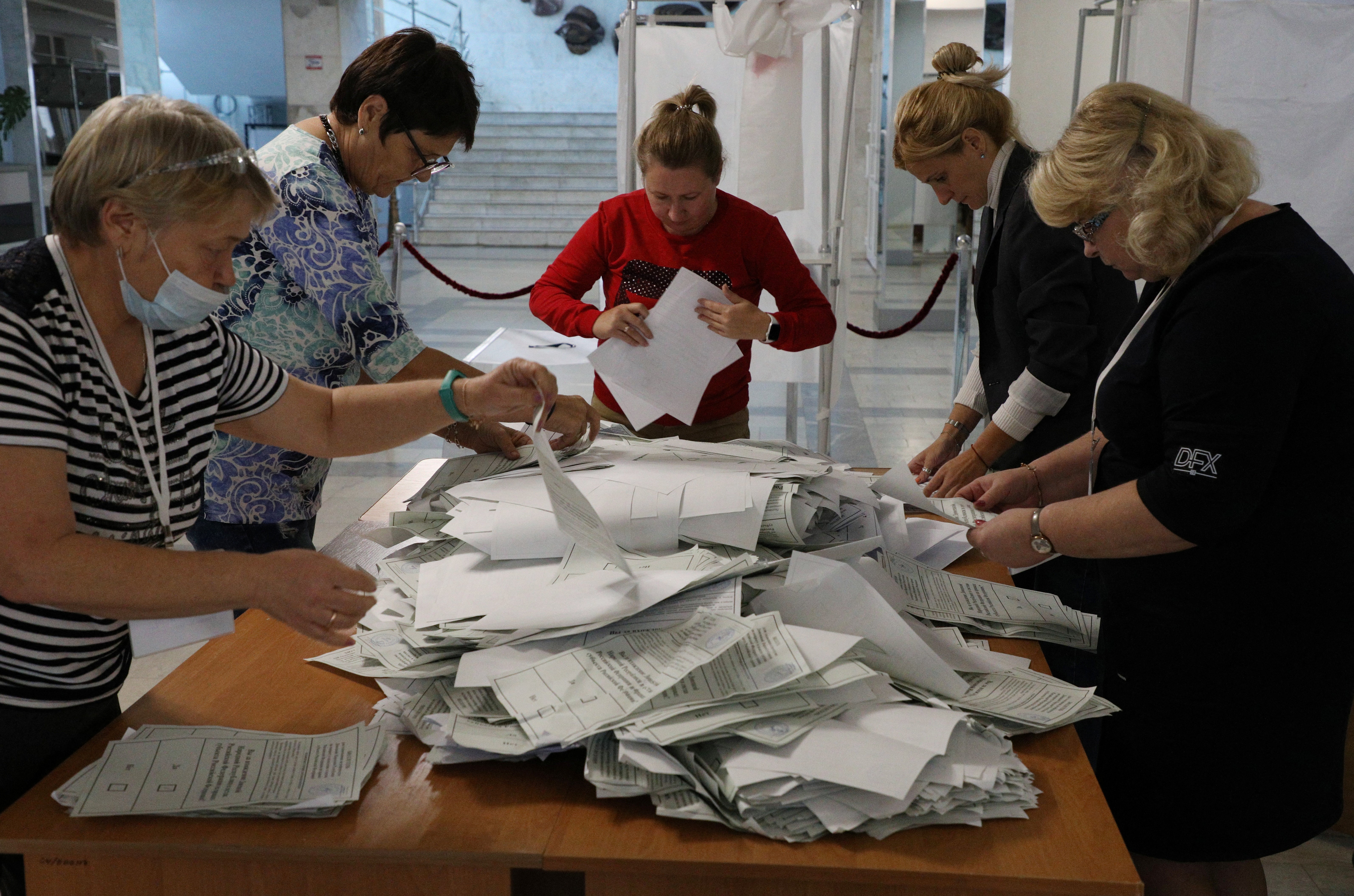 Members of a local electoral commission count ballots at a polling station in Sevastopol