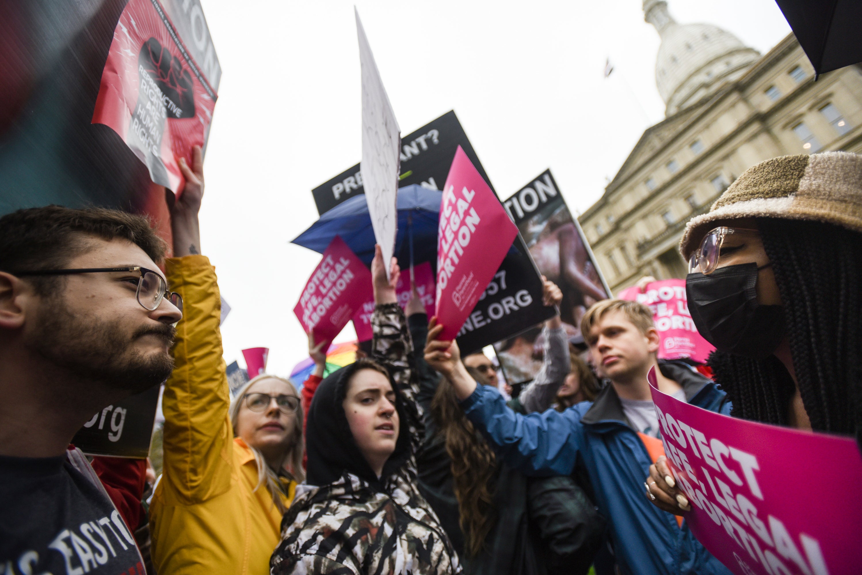 Abortion-rights advocates, right, try to block anti-abortion signage during a rally at the state capitol in Lansing, Mich., May 2, 2022, in support of abortion rights after a draft of the Supreme Court opinion was leaked in favor of overturning Roe v. Wade. (Matthew Dae Smith/Lansing State Journal via AP, File)