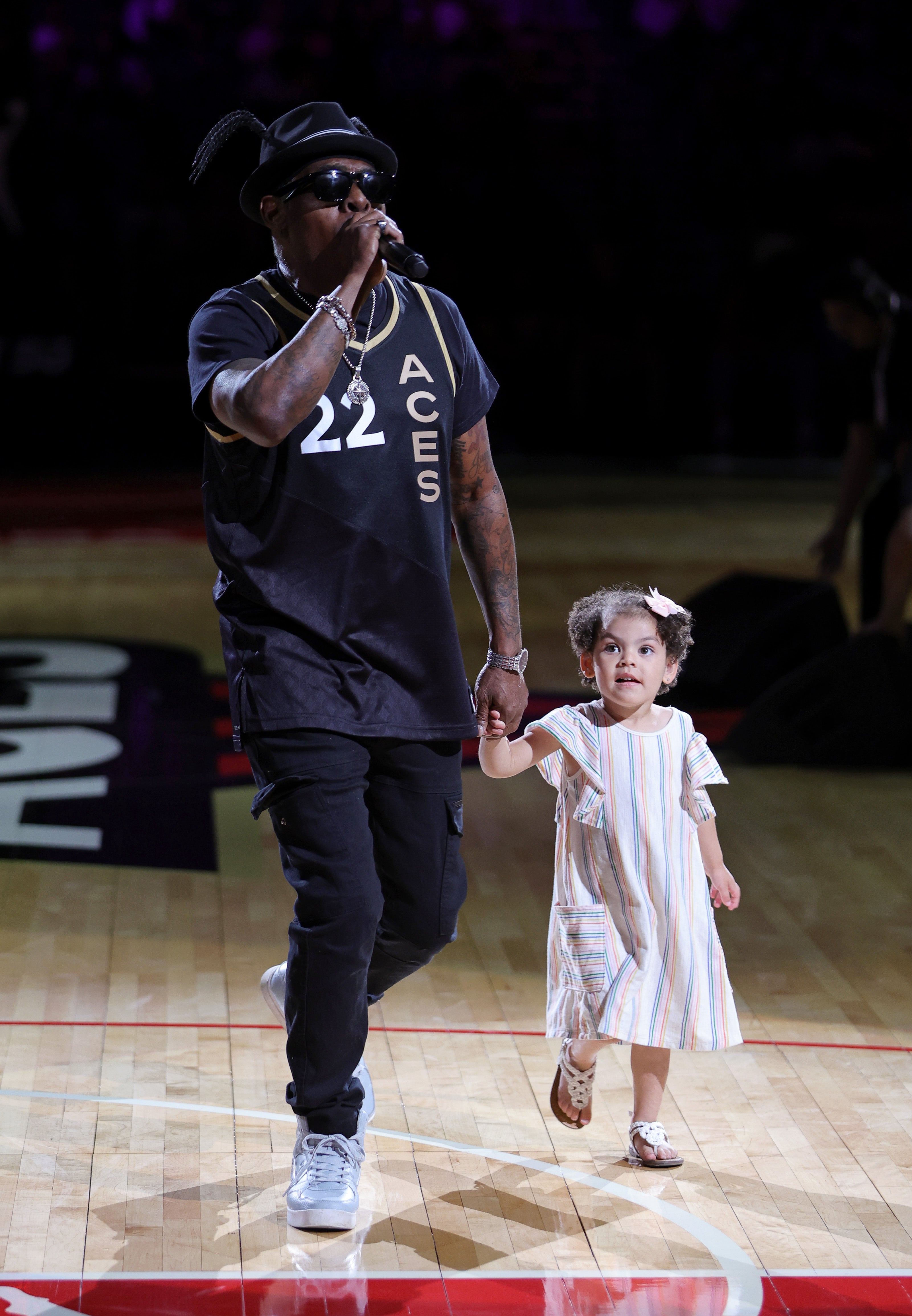 Rapper Coolio and his granddaughter Arya Ivey perform at halftime