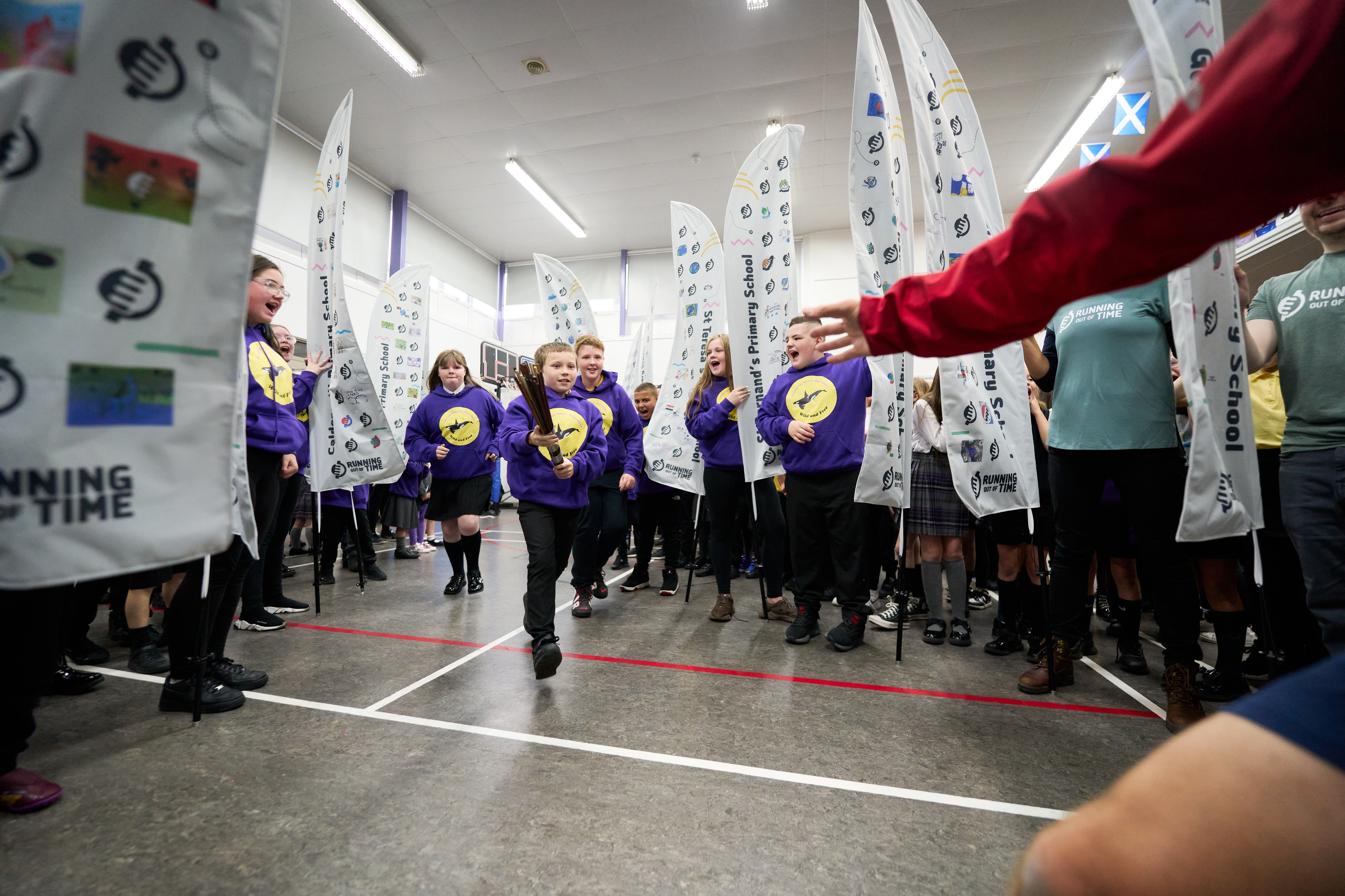 Children at Sunnyside Primary School in Glasgow at the opening stage of the Cop 27 baton relay (Hamish Frost/PA)