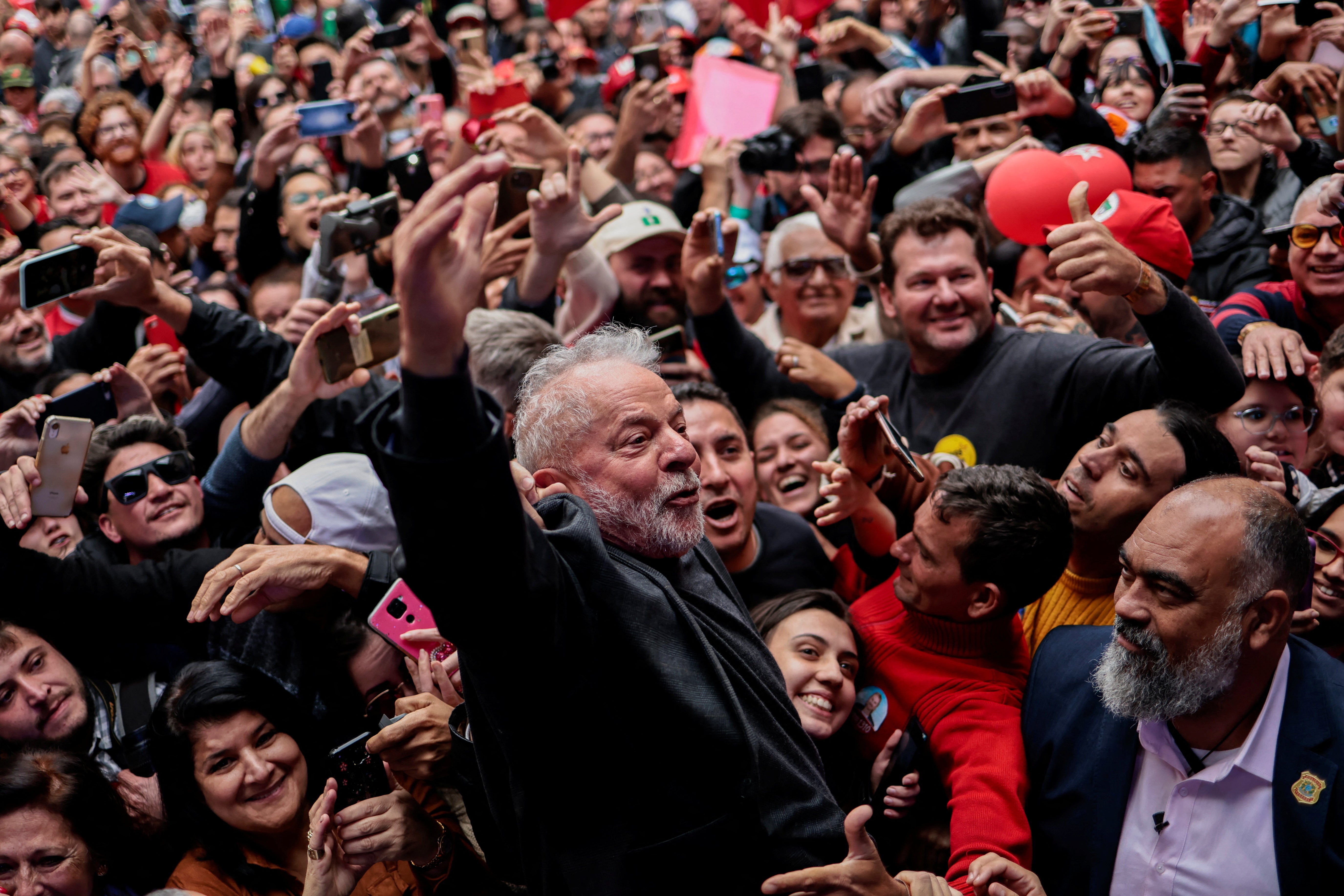 Lula greets supporters during a rally in Curitiba