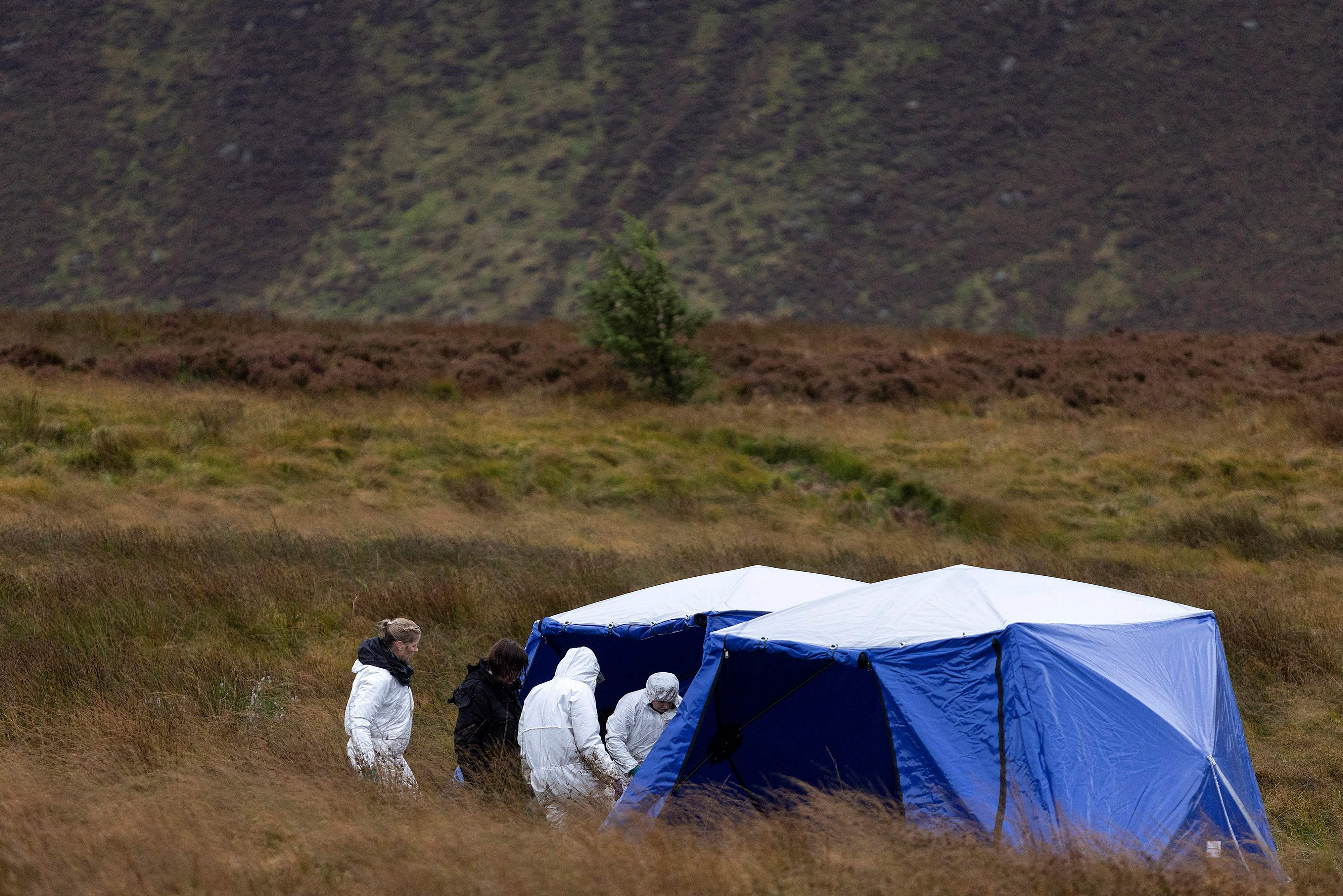 A picture released by Greater Manchester Police on September 30 shows police forensics officers working in an area of Saddleworth Moor, near Manchester, northwest England