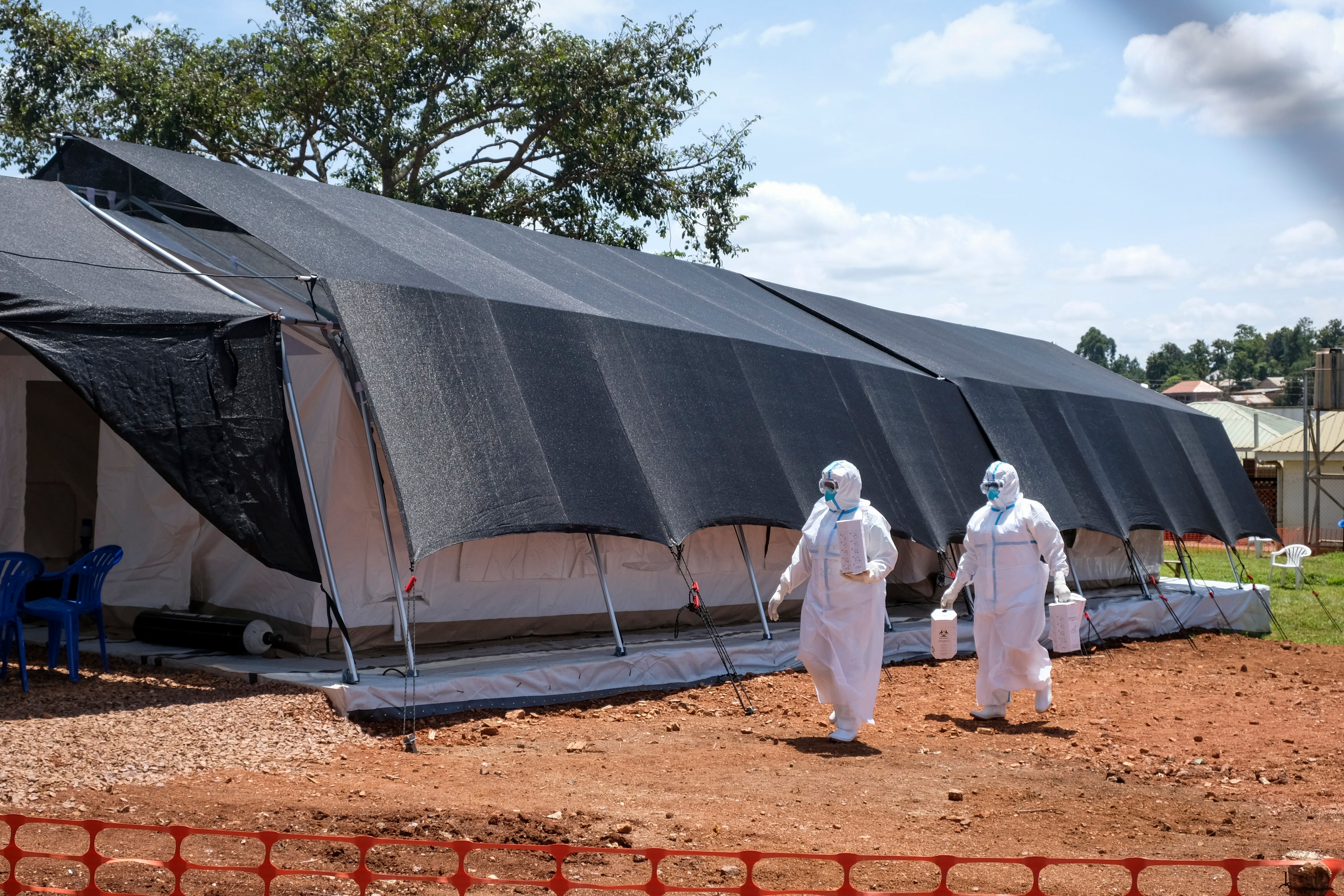 Doctors walk inside the Ebola isolation section of Mubende Regional Referral Hospital, in Mubende, Uganda