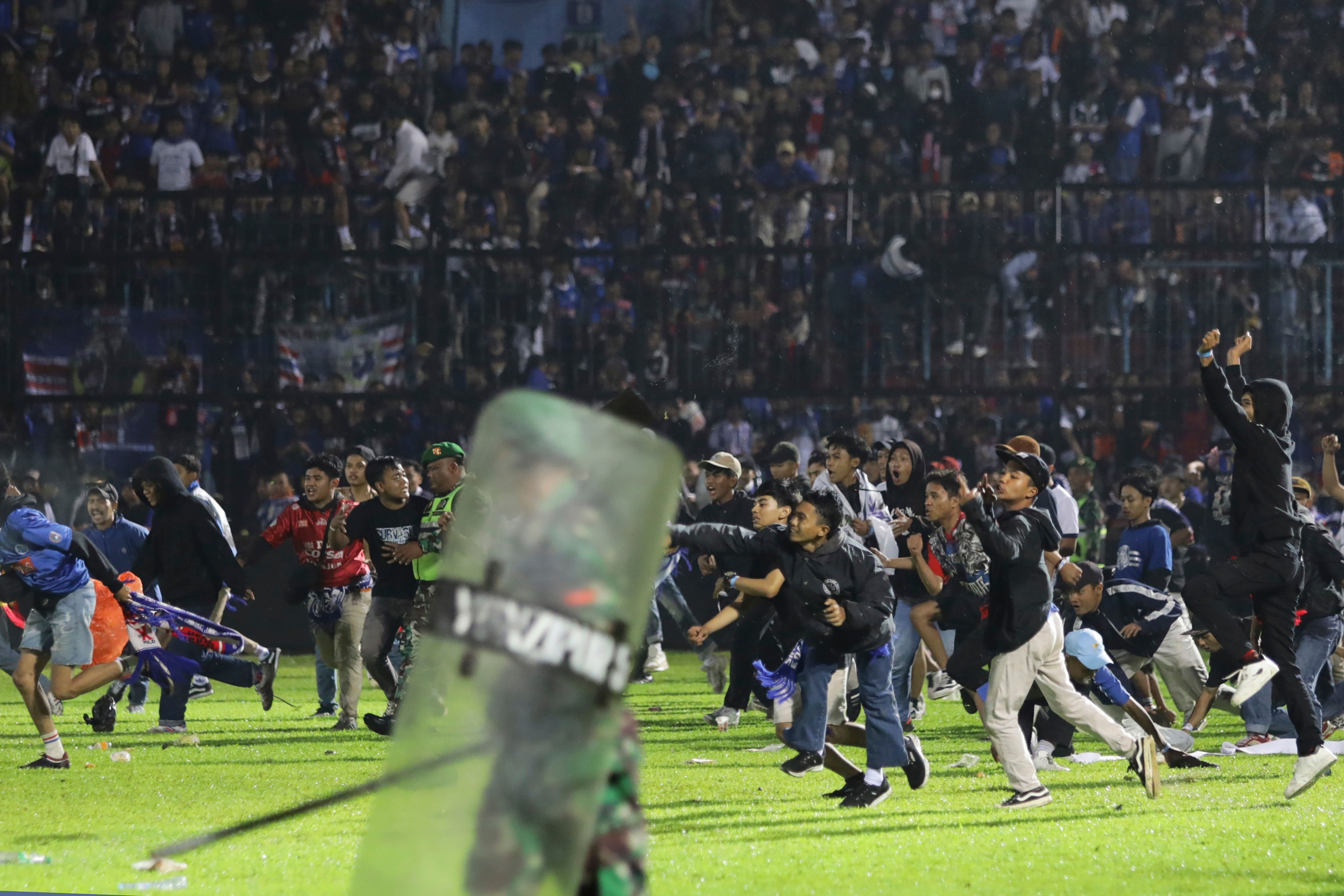 At least 125 people die in football stadium crush in Indonesia following ticket oversell