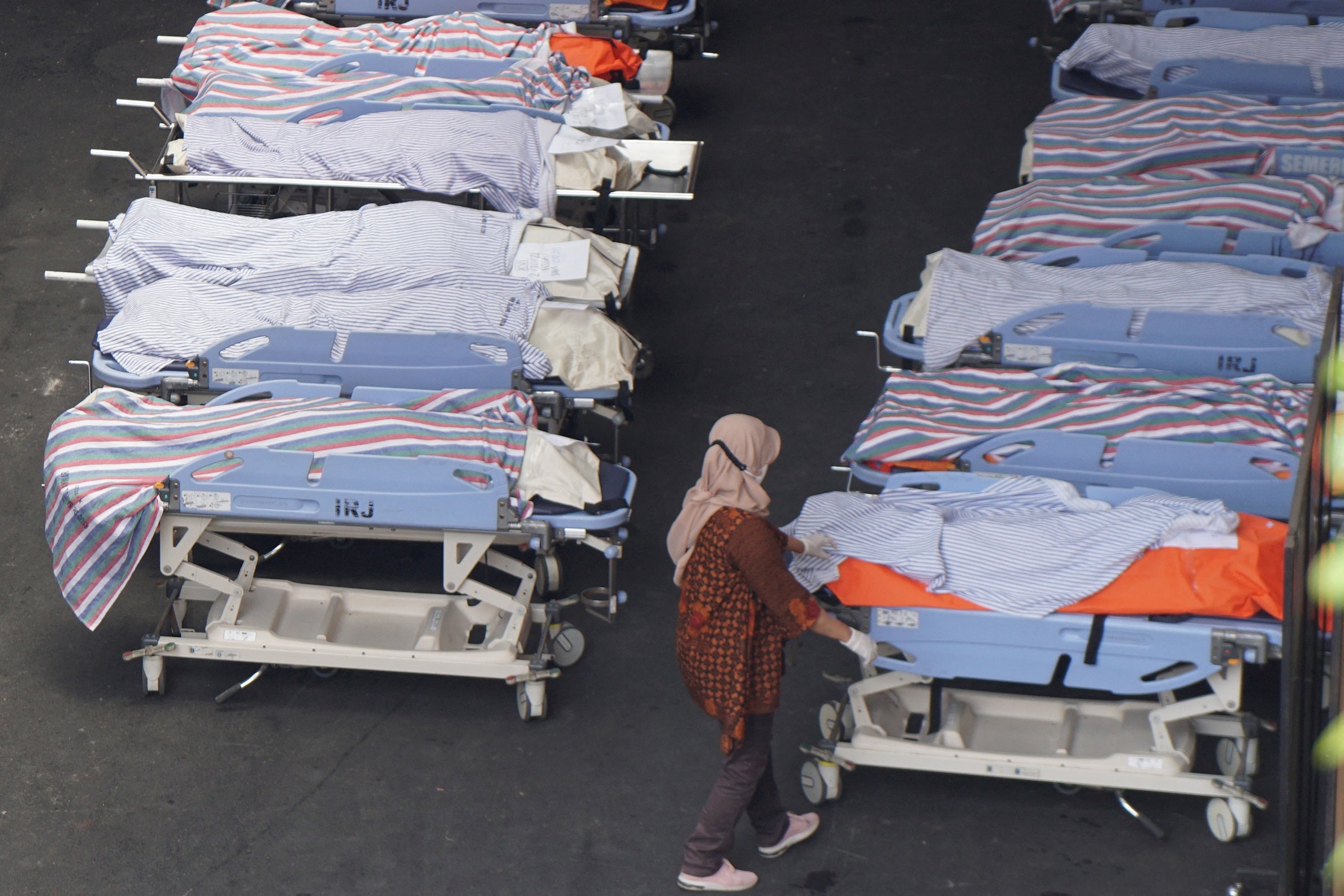 A medical officer checks on victims at Saiful Anwar hospital