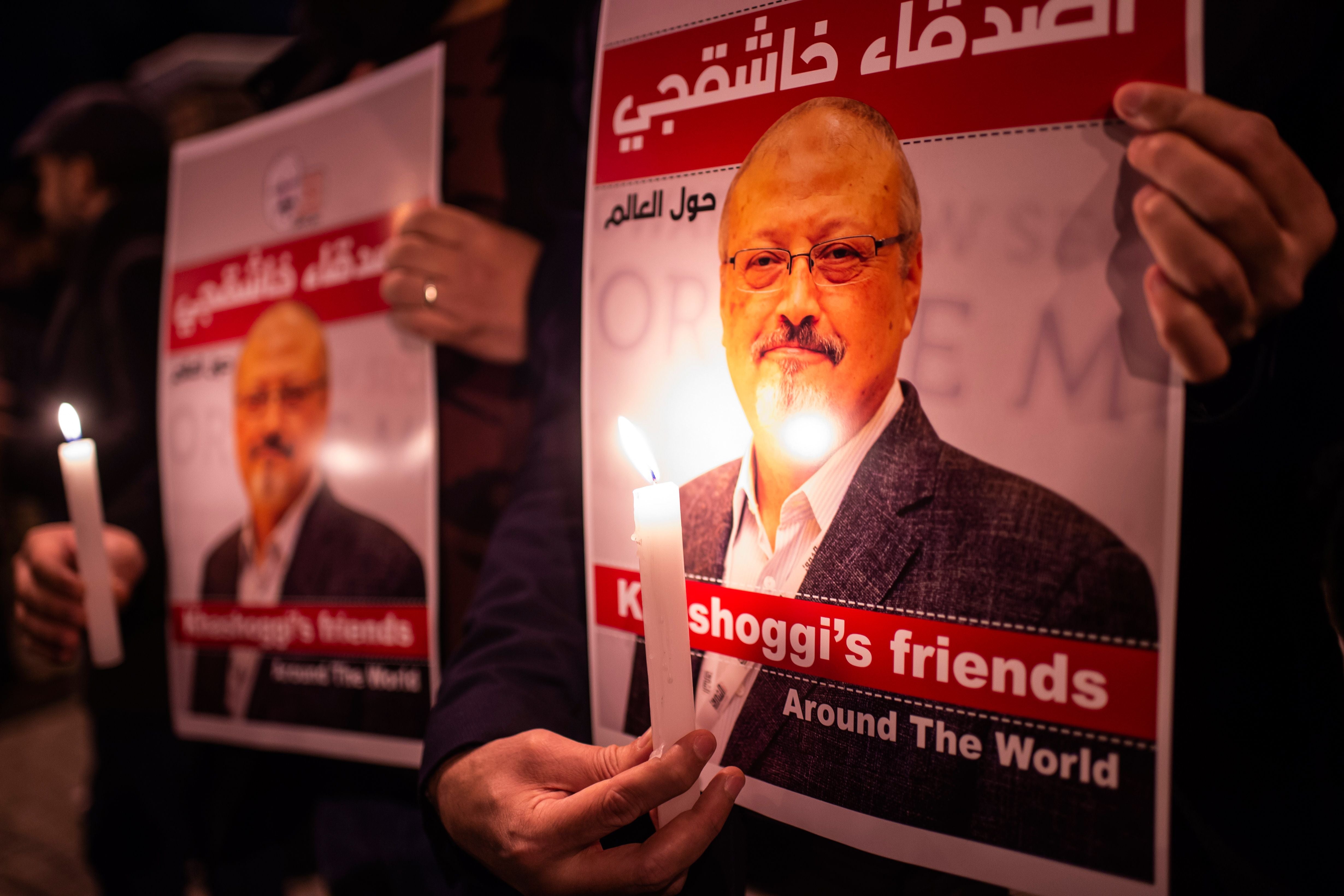 People hold posters picturing Saudi journalist Jamal Khashoggi