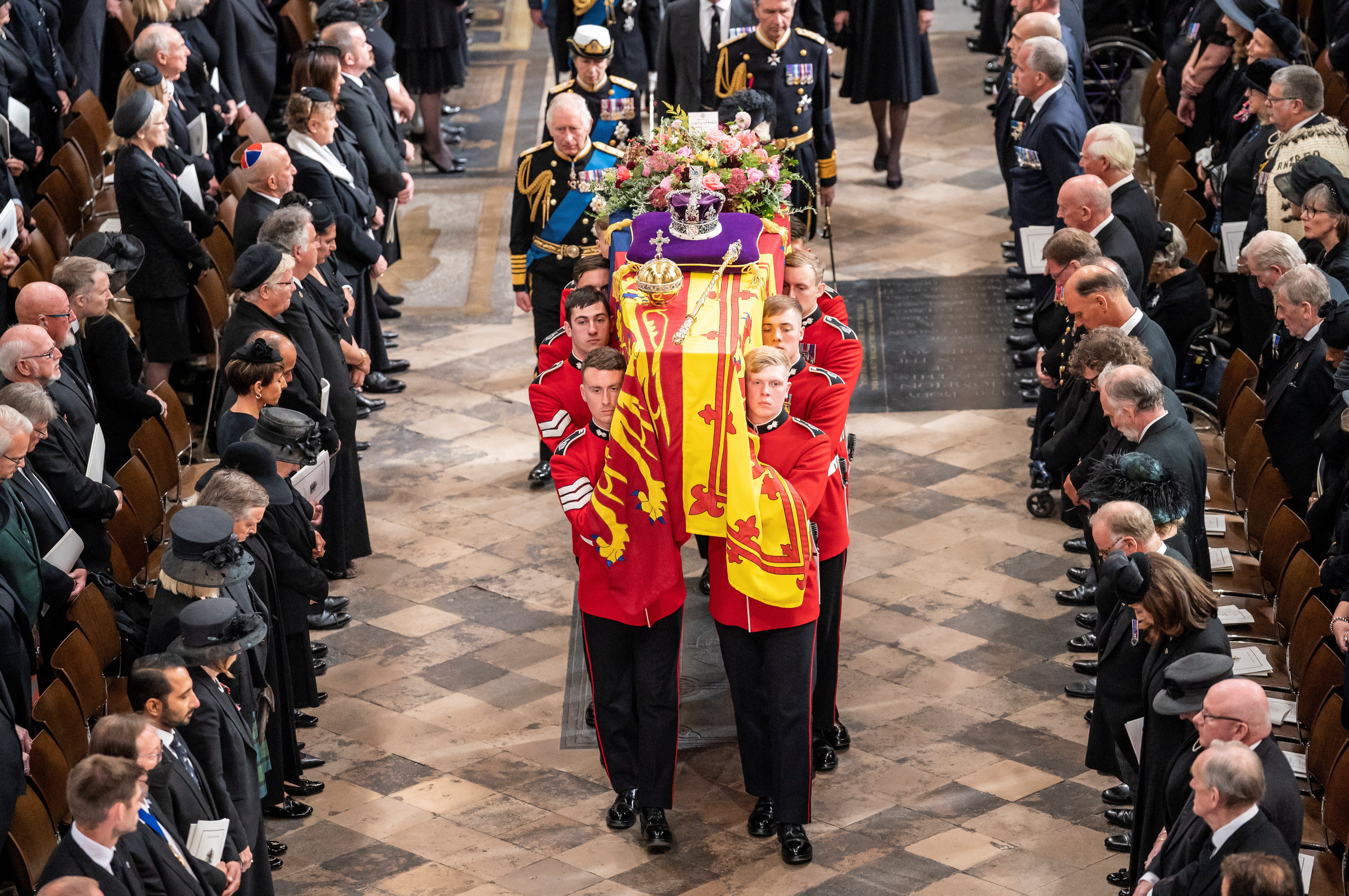 Thousands of people lined the streets to watch the coffin make its way along the Royal Mile