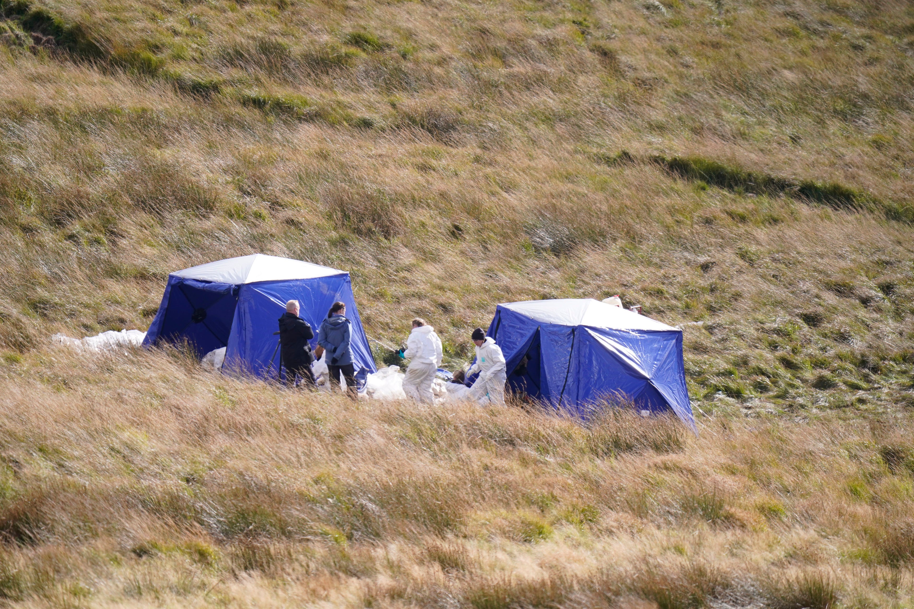 Officers from Greater Manchester Police continue a search on Saddleworth Moor, in north west England, for the remains of the body of 12-year-old Keith Bennett