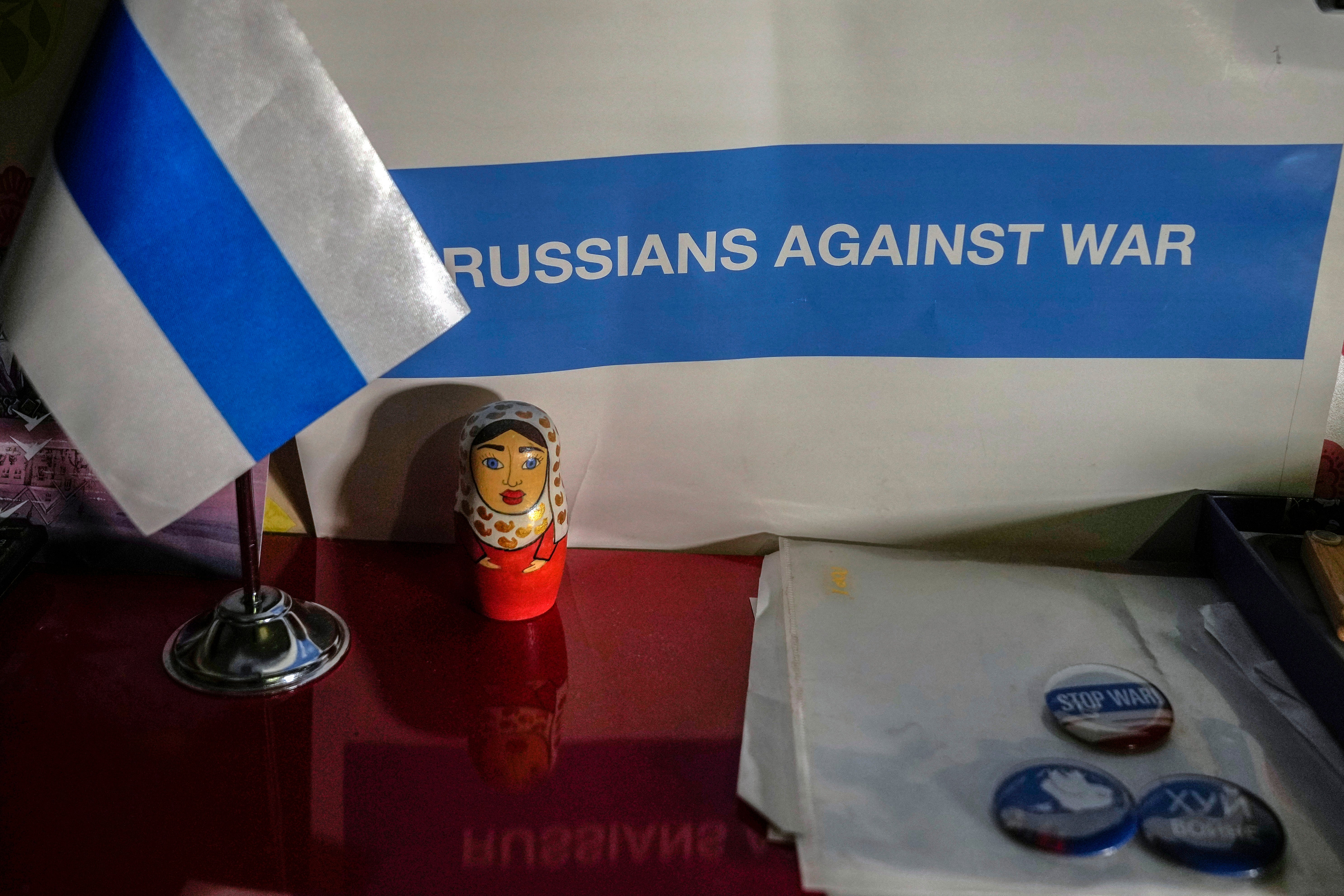 A “Russians Against War” poster hangs inside the home of Eva Rapoport, the Istanbul coordinator for The Ark, a group helping Russians fleeing their country, in Istanbul