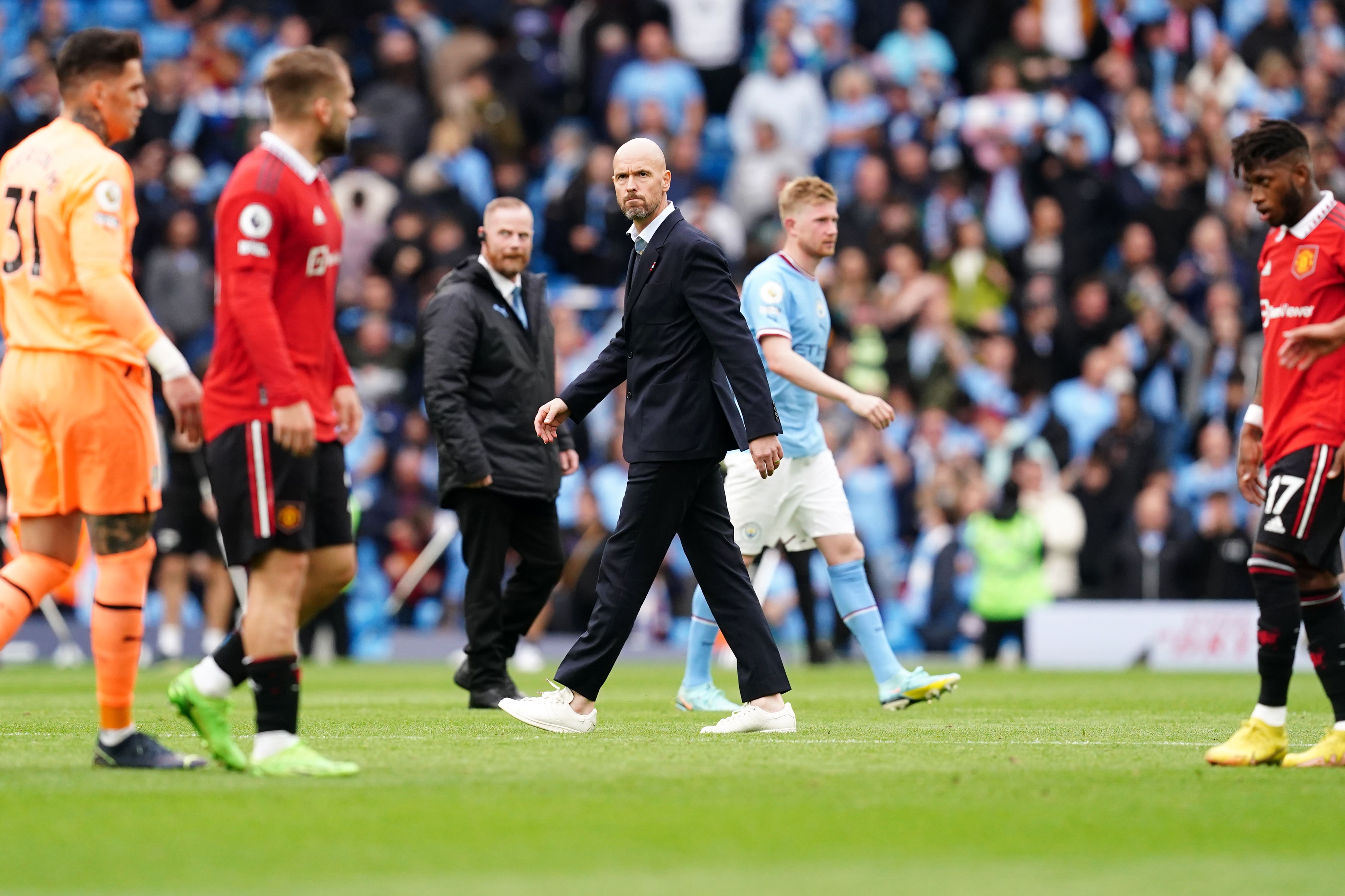 Erik ten Hag and his Manchester United players react following their derby thrashing (Martin Rickett/PA)