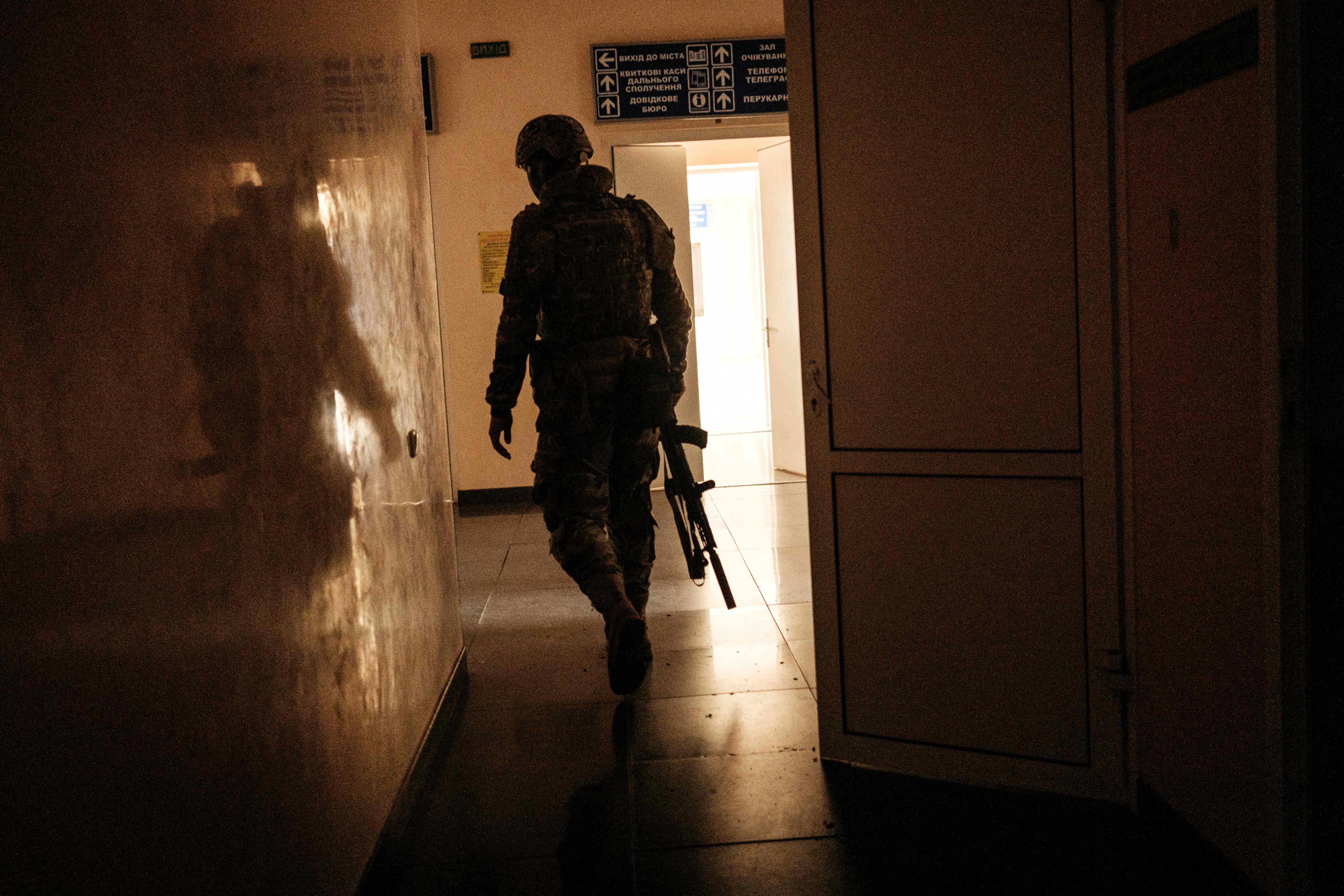 A Ukrainian soldier patrols in the recently retaken railway station in Kupyansk Vuzlovyi, Kharkiv region, on Sunday