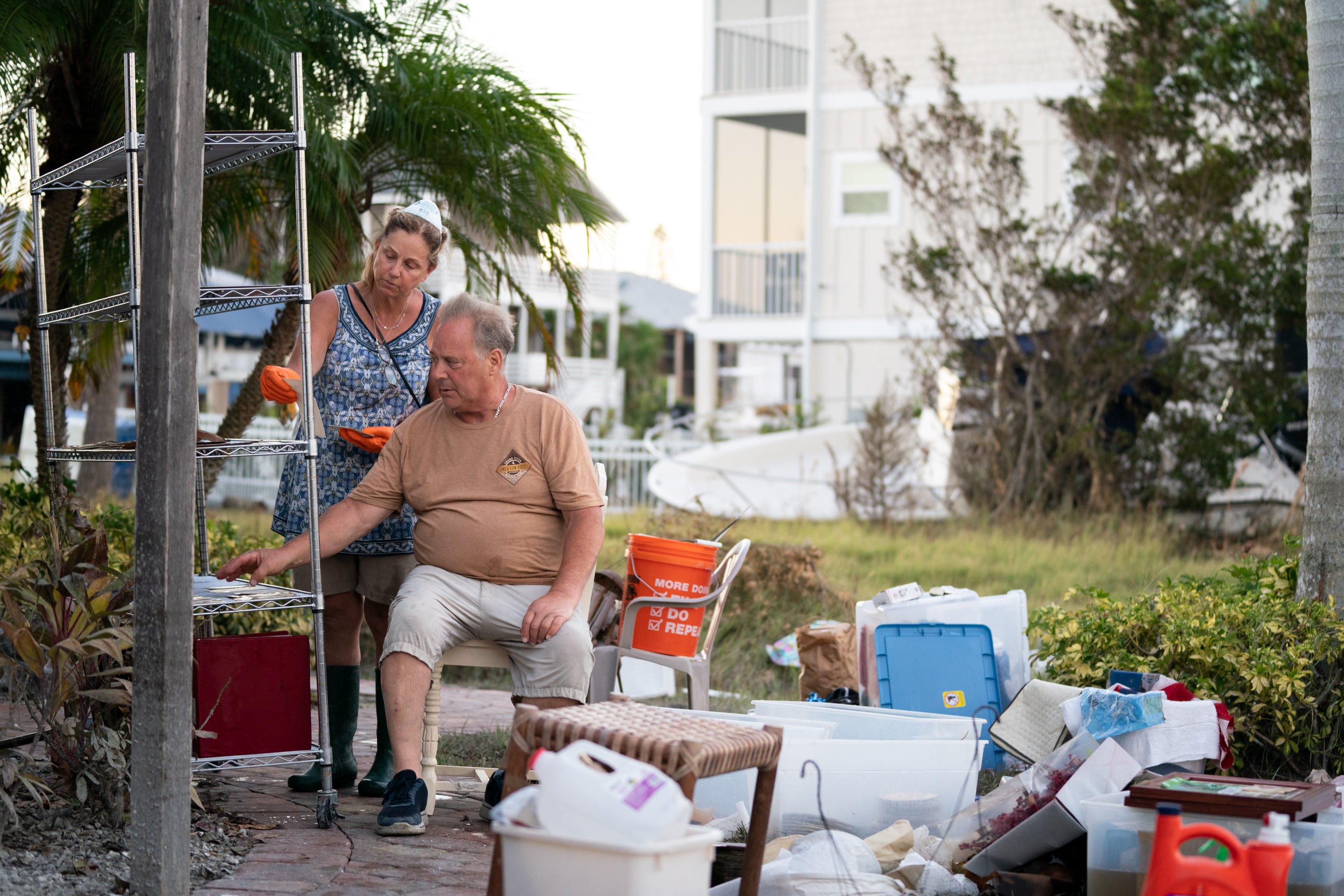 People in Naples, Florida go through family photos damaged by floodwaters in Hurricane Ian