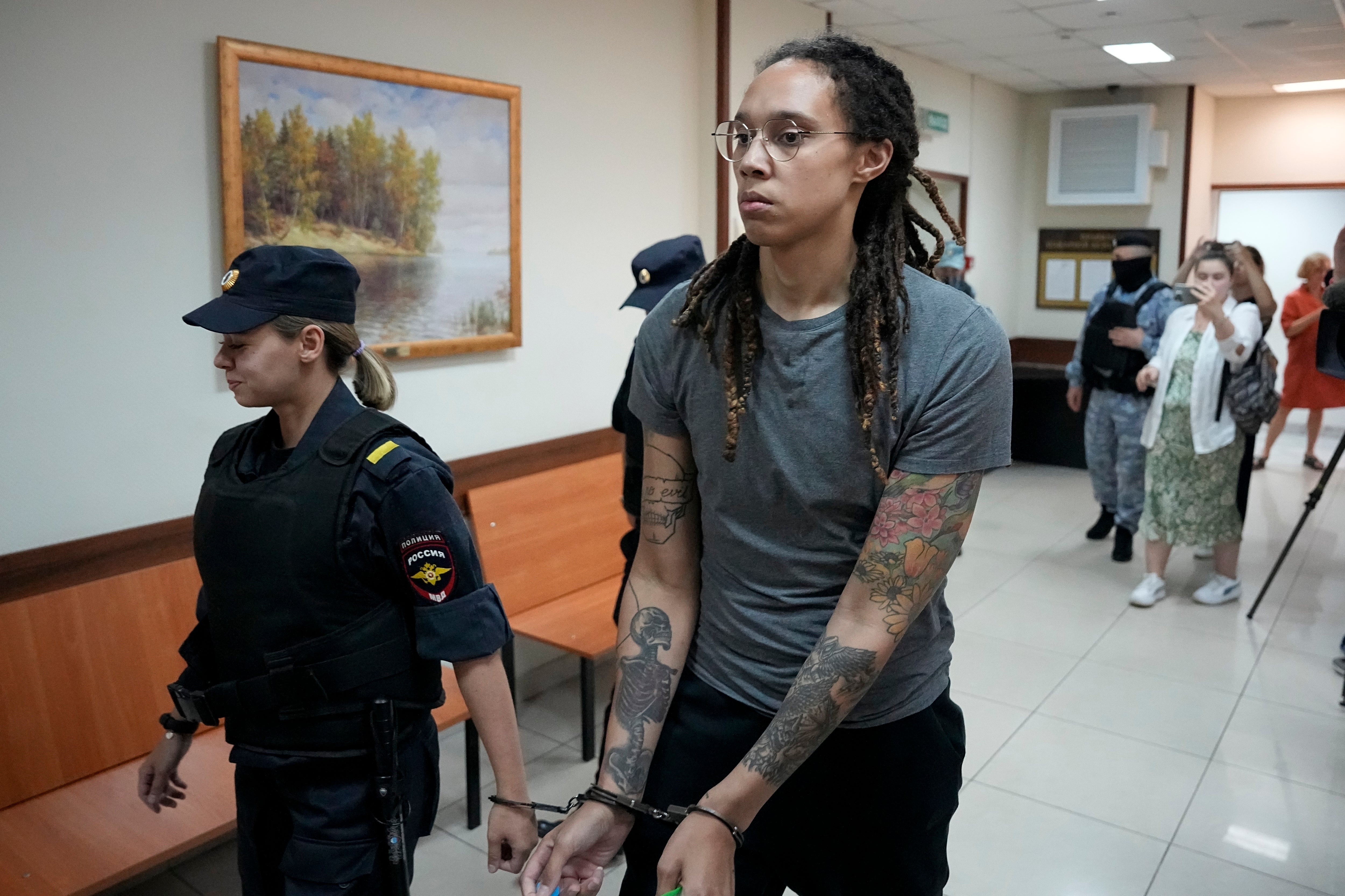 FILE - WNBA star and two-time Olympic gold medalist Brittney Griner is escorted from a Russian court room