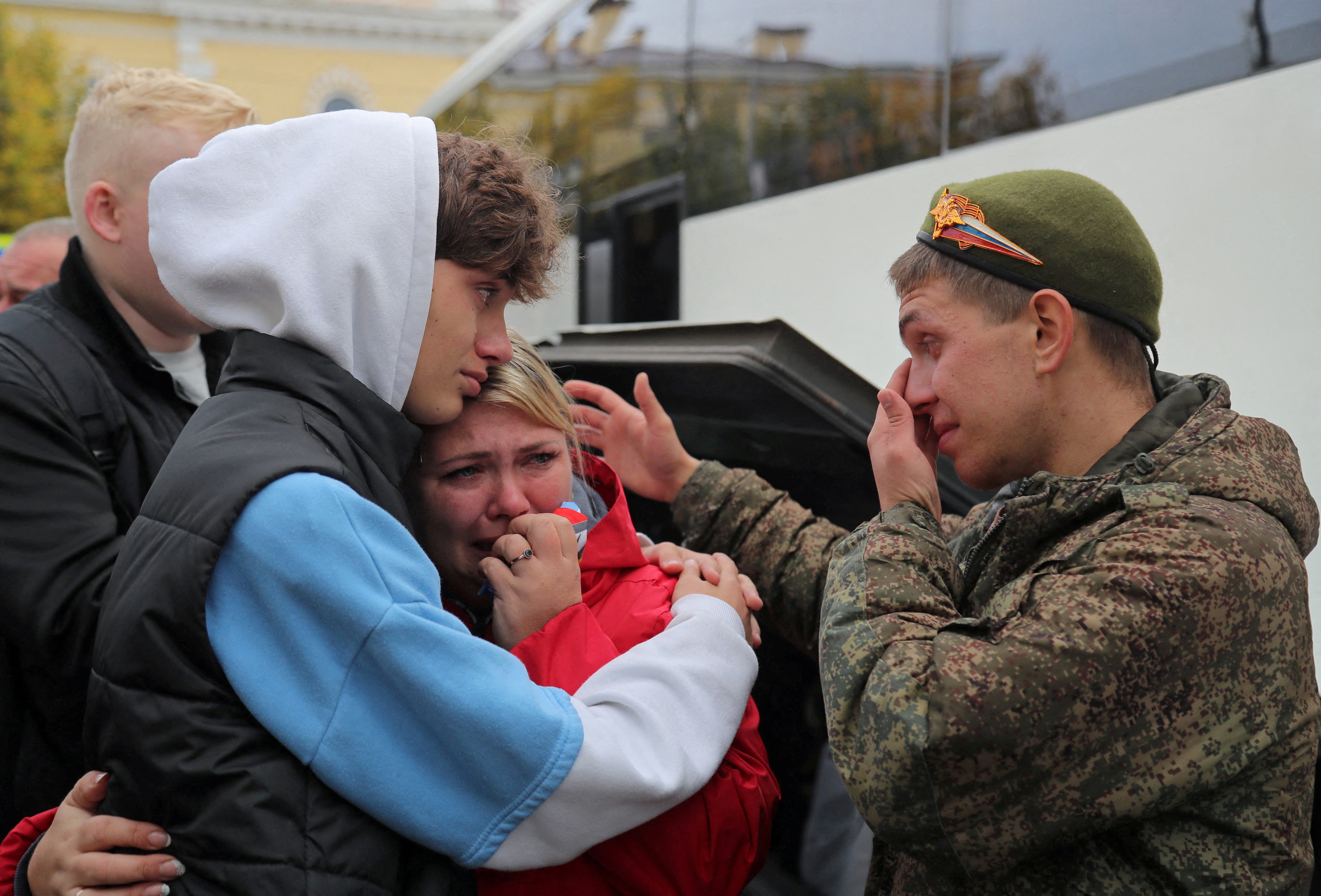 A Russian reservist bids farewell to relatives before his departure for a base in the course of partial mobilisation of troops