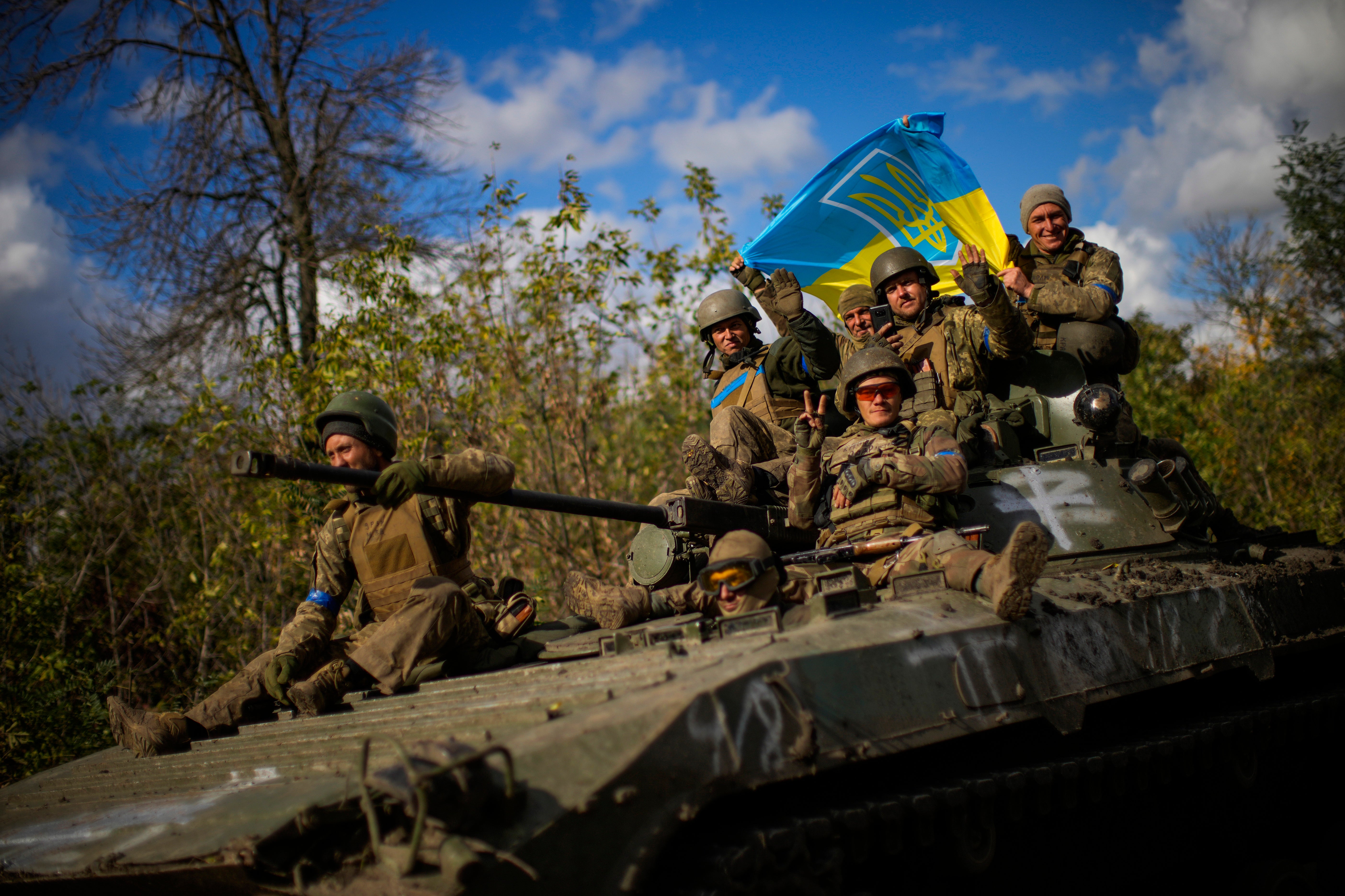 Ukrainian soldiers sitting on a tank close to the recpatured town of Izyum