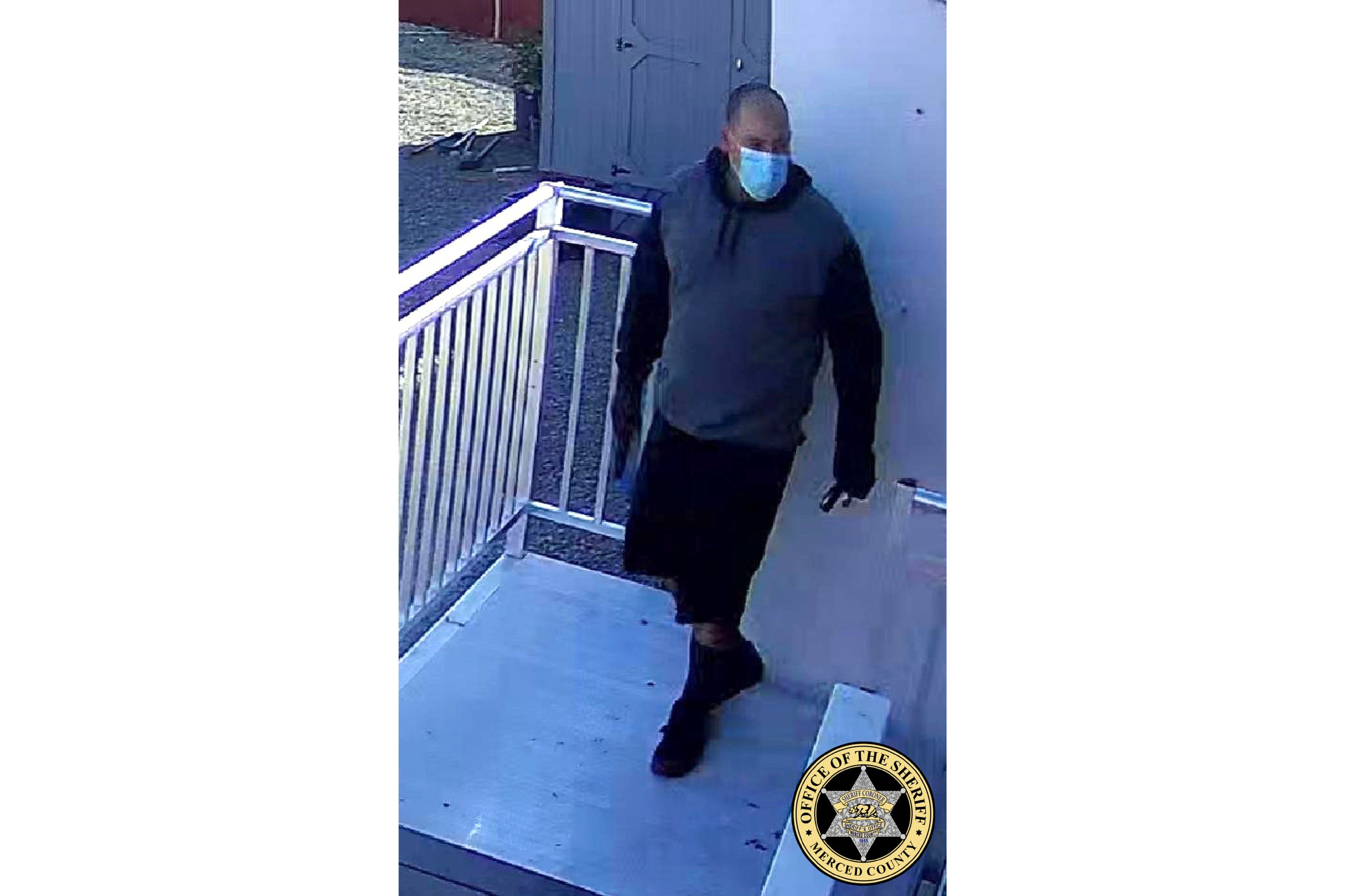 This undated image released by Merced County Sheriff’s Office shows a person of interest outside the kidnapped family’s business