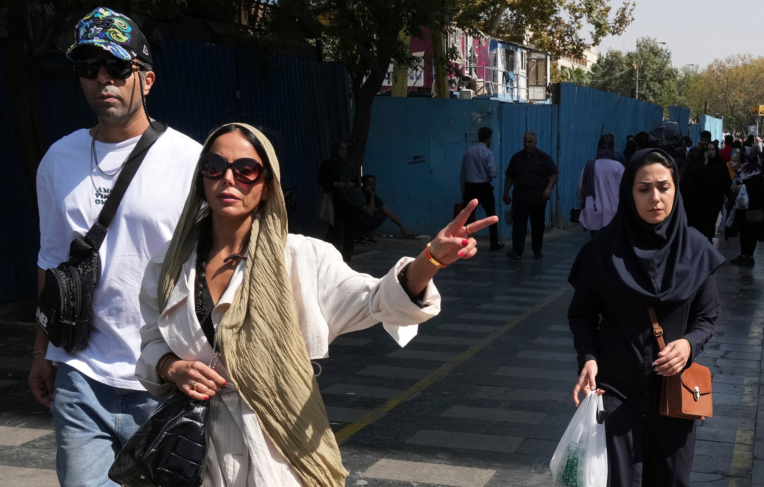 A woman flashes a victory signal in Tehran