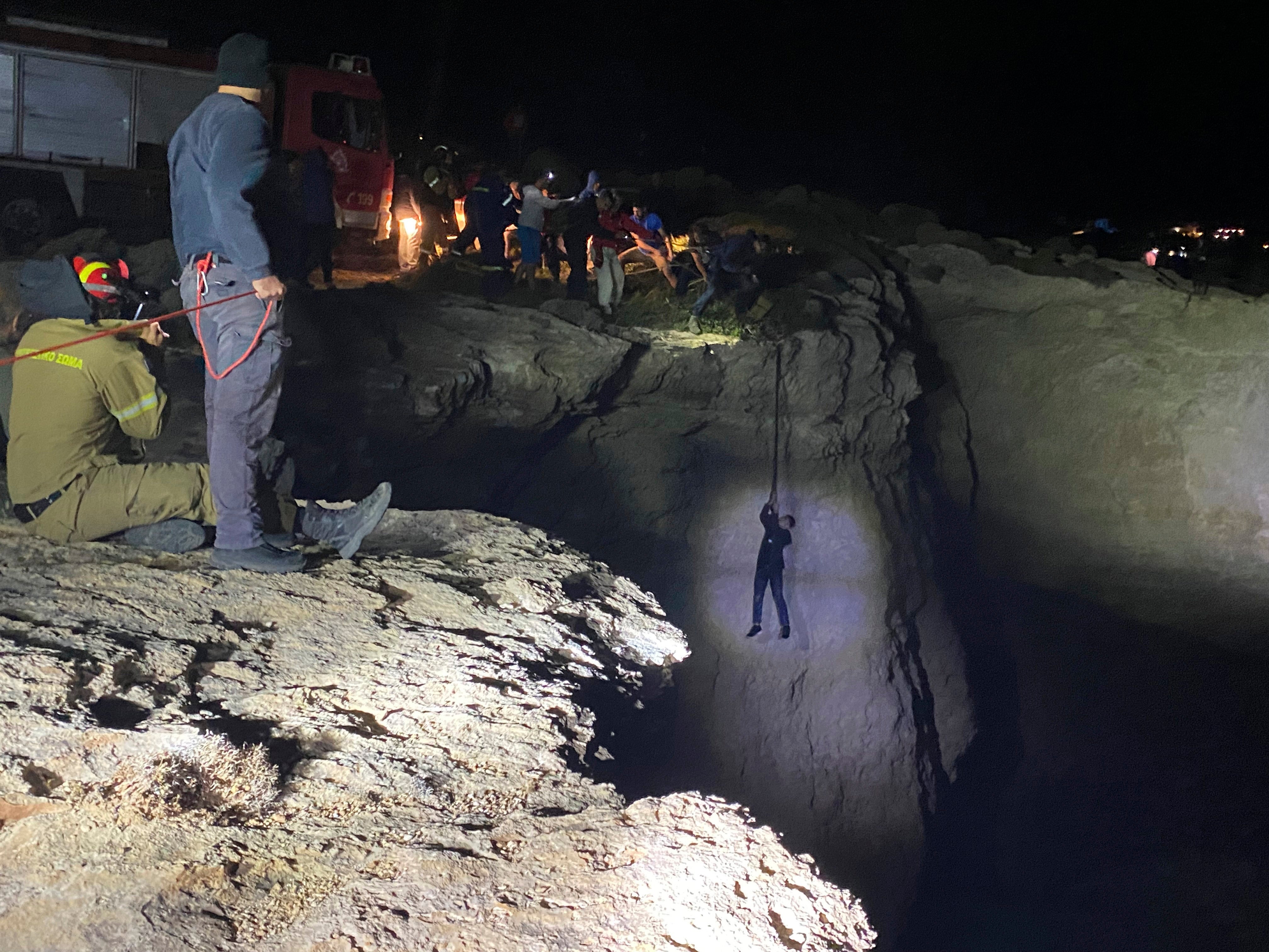 Authorities and local residents save a migrant during a large-scale rescue operation on the island of Kythira