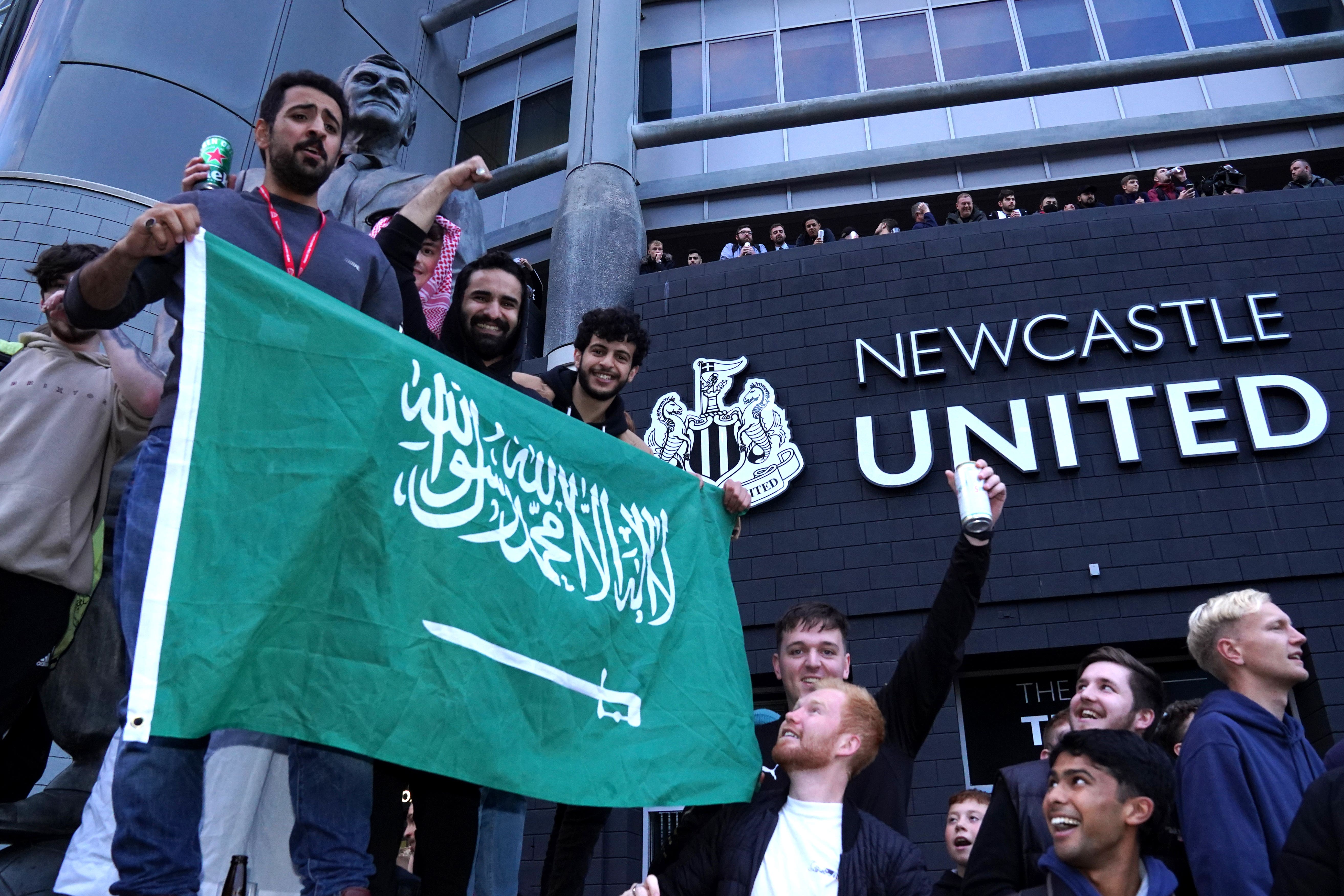 Newcastle fans celebrate the takeover of their club on October 7 last year (Owen Humphreys/PA).