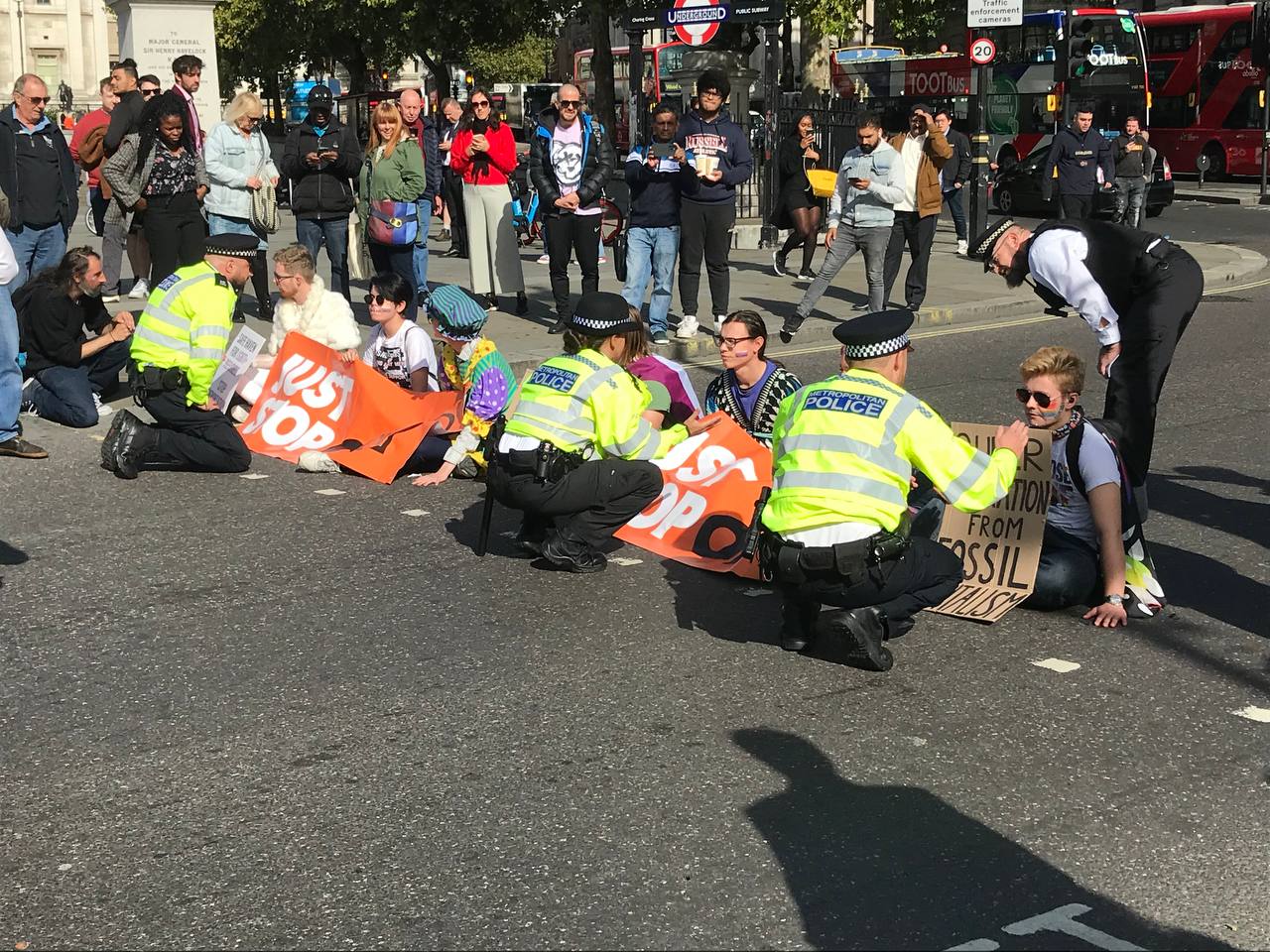 The protestors appear to have glued their hands to the road surface